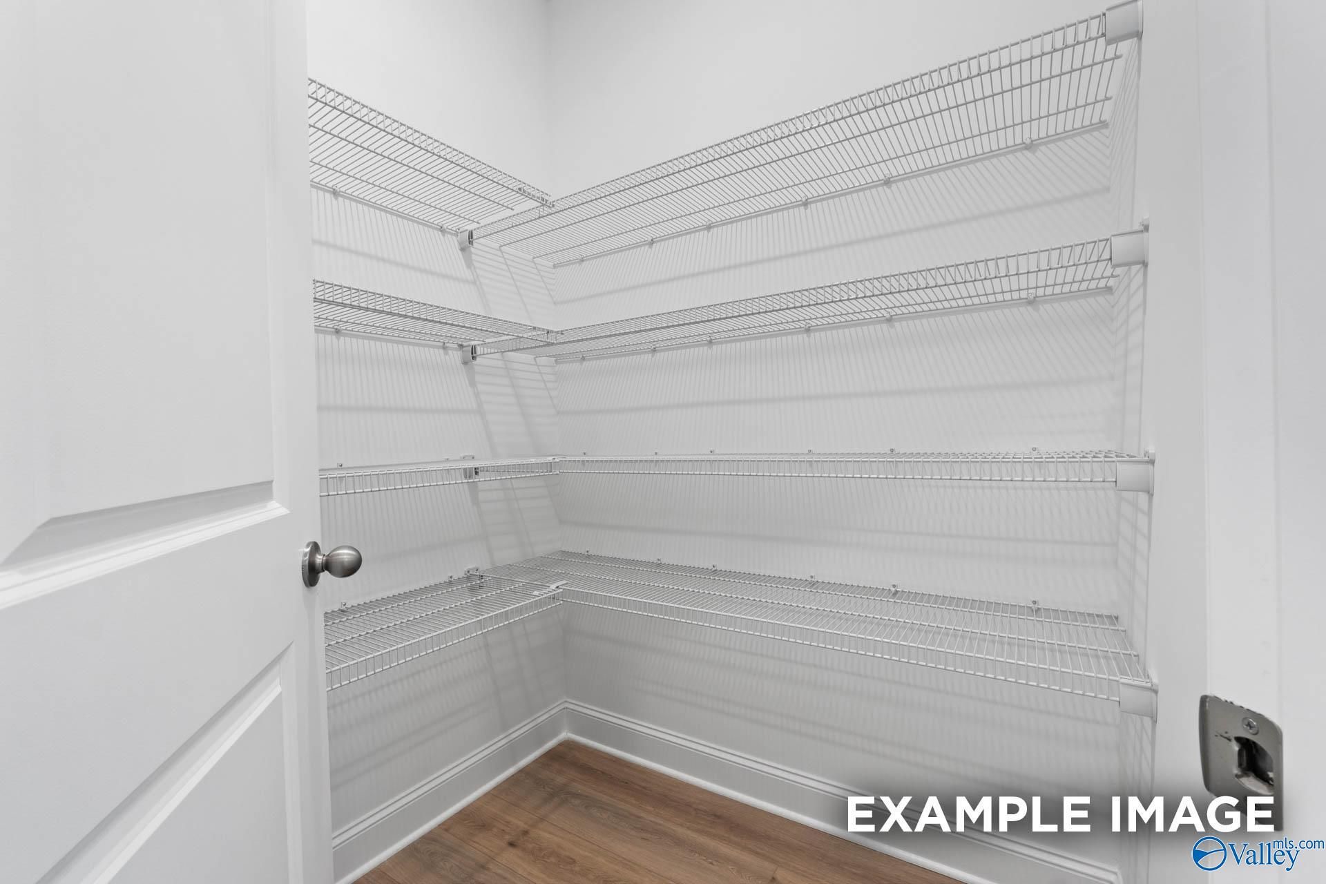 Spacious walk-in pantry with multi-tiered wire shelving in Davidson Homes The Oxford, Riverton Preserve, Huntsville, Alabama