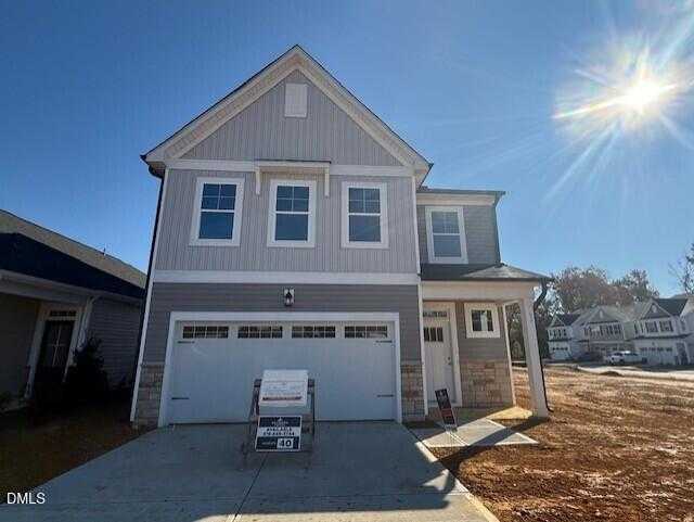 Modern two-story gray home with two-car garage and for-sale sign by Davidson Homes in Gregory Village, Lillington, NC