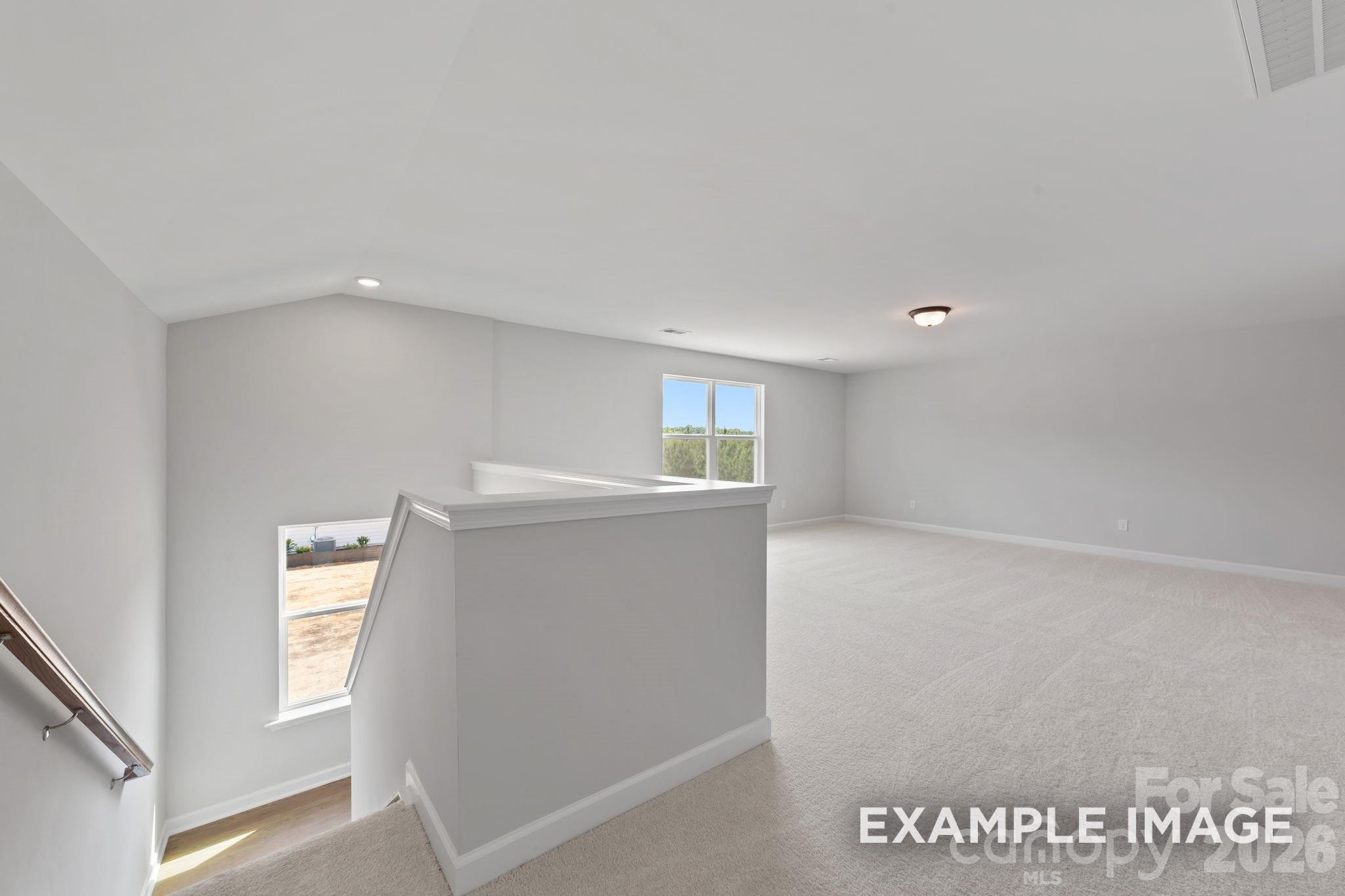 Spacious carpeted loft area in The Magnolia B floor plan by Davidson Homes in Windgate, Mooresville, North Carolina.