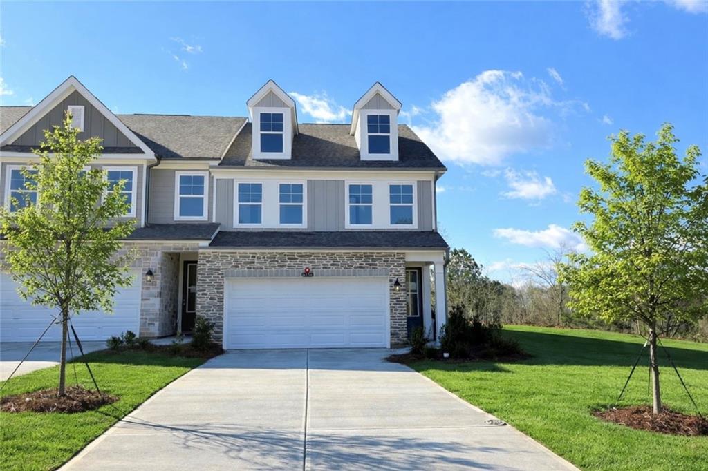 Modern two-story 3-bedroom home with 2-car garage, stone accents, and landscaped yard in Hemingway, Cumming, Georgia - Davidson Homes The Durham B