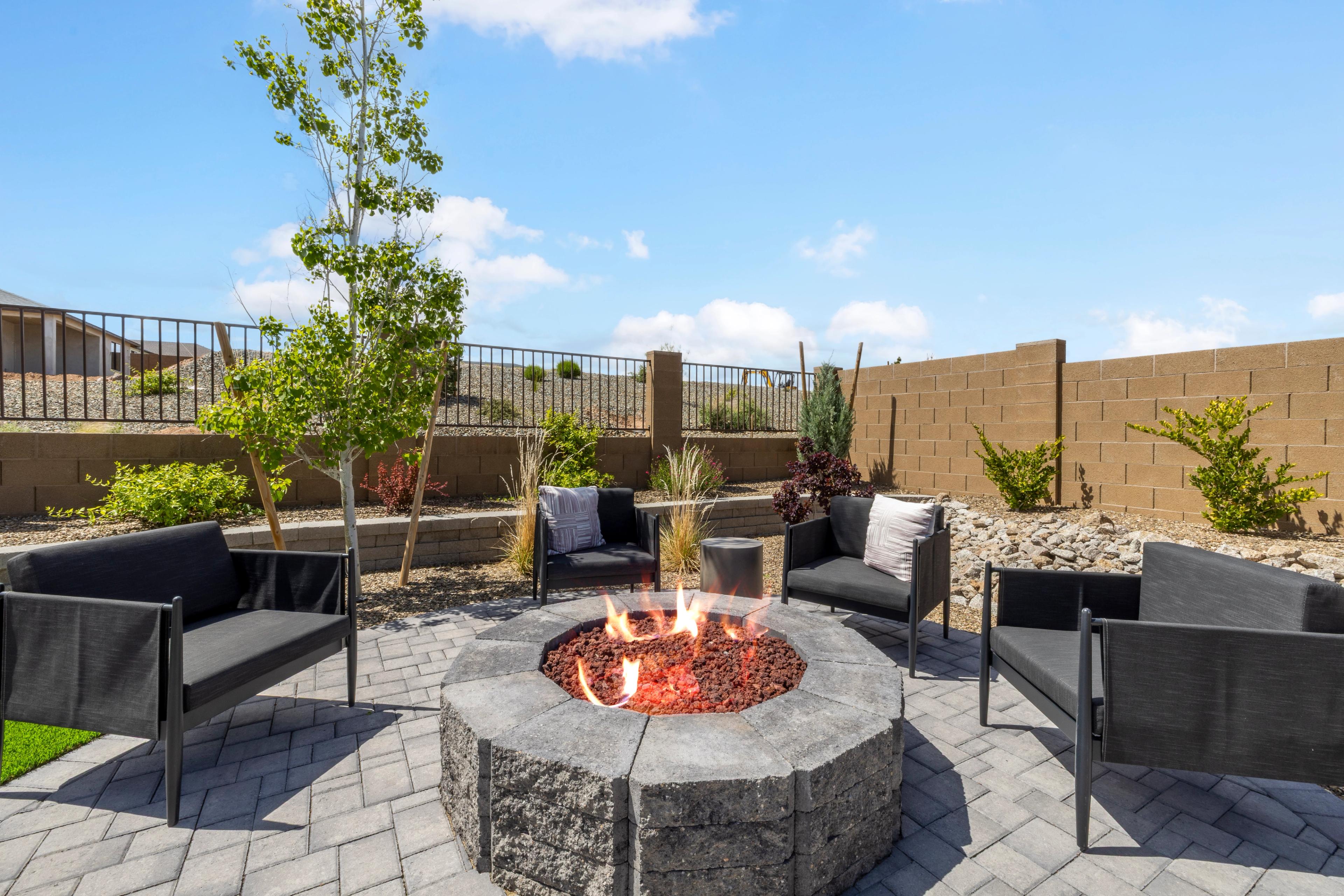 Cozy outdoor fire pit with modern black seating at South Ranch Western Collection in Prescott AZ, paver patio and desert landscaping