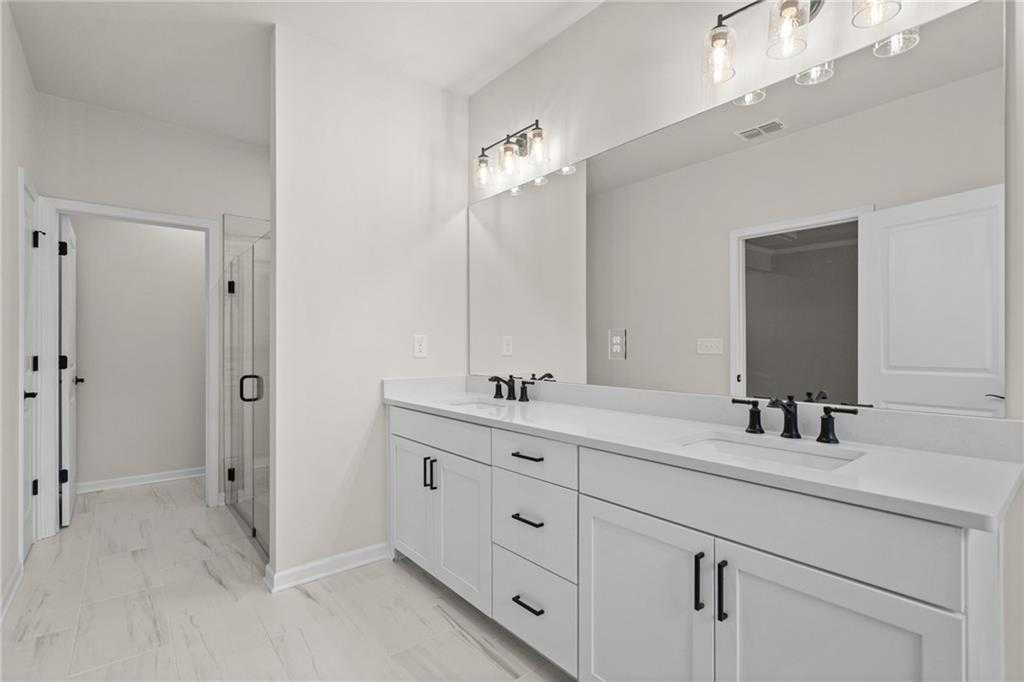 Modern master bathroom with double vanity, frameless glass shower in Davidson Homes The Glenwood A, Loganville, GA