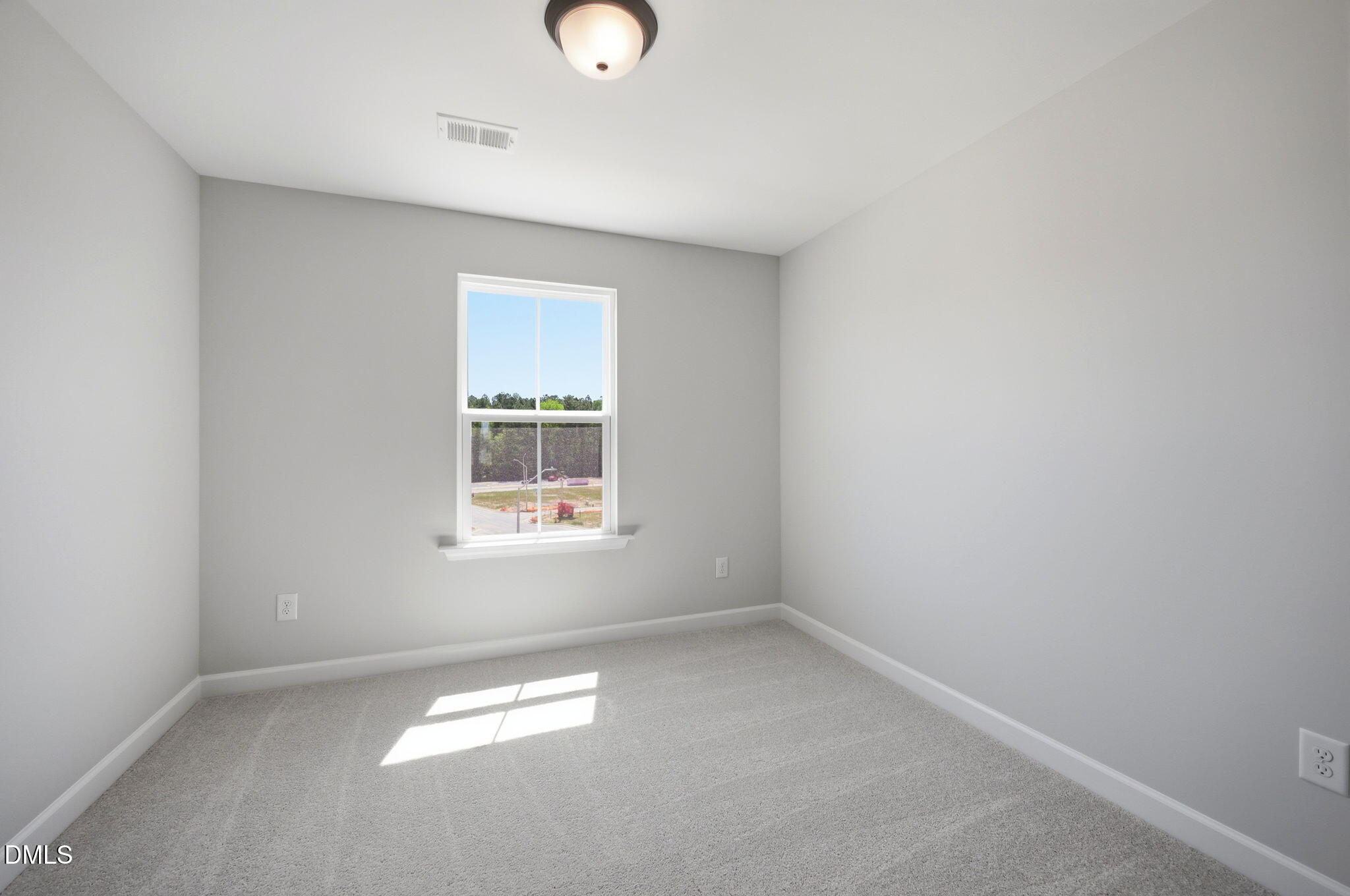 Bright, neutral bedroom with plush carpeting in The Avery floor plan at Forestville Yard Townhomes in Knightdale, NC.