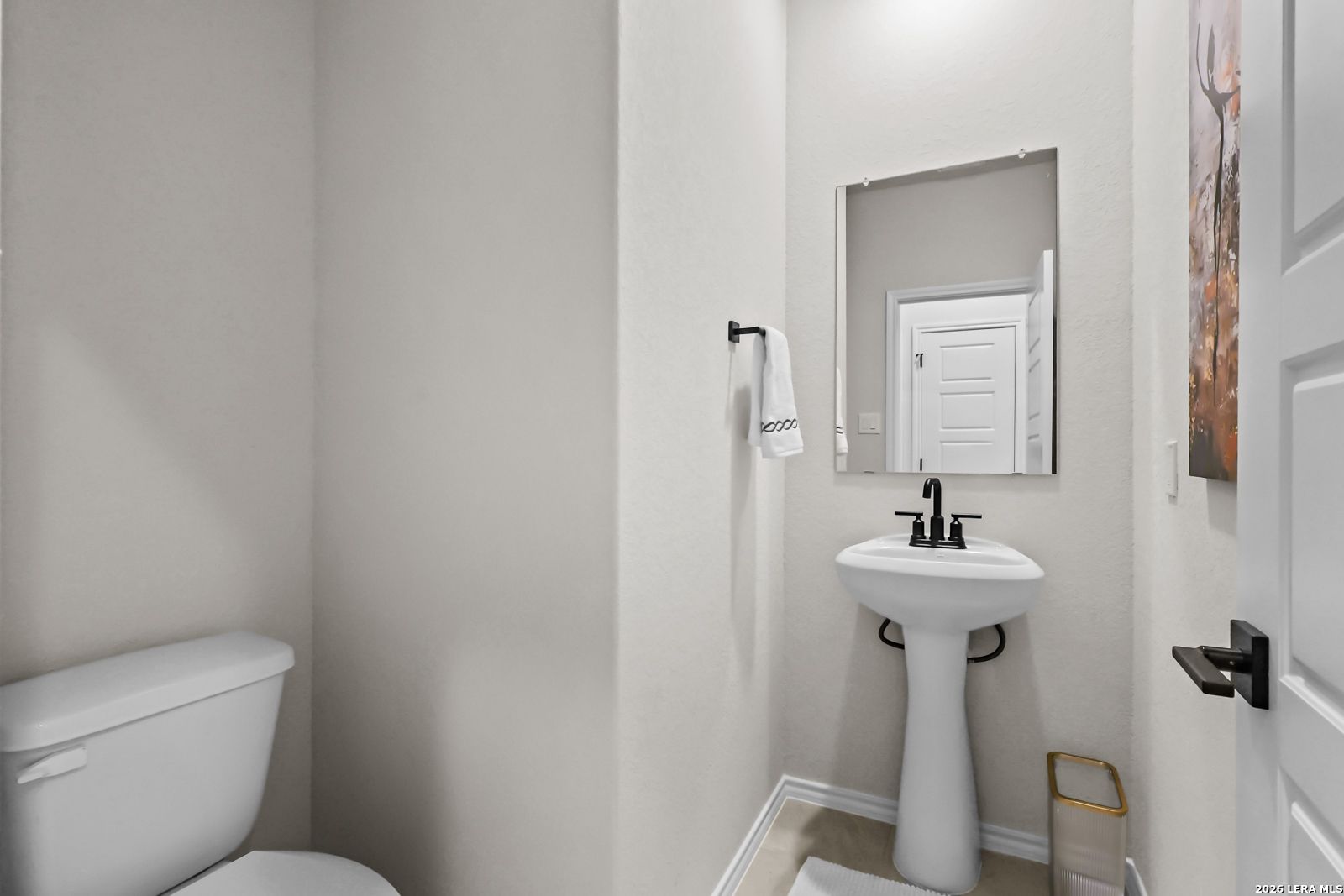 Modern powder room with pedestal sink in The Douglas C floor plan at Hannah Heights, Seguin, Texas.