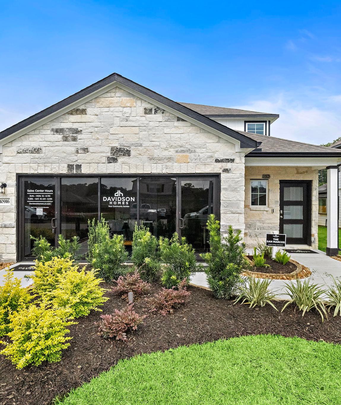 Modern kitchen at Liberty Estates in Cleveland Texas by Davidson Homes featuring white cabinets granite island red bar stools and stainless appliances