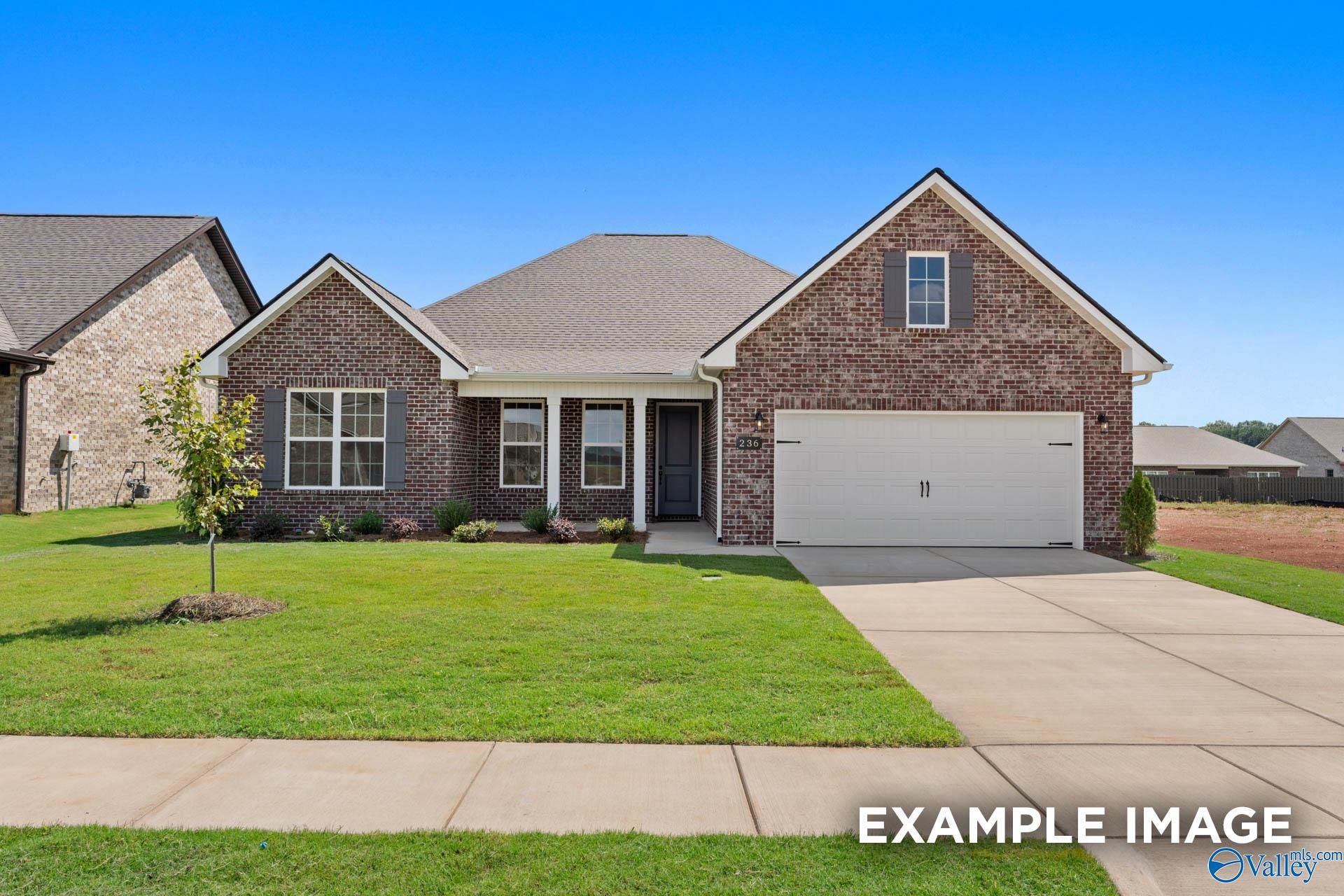 Brick single-story home with 2-car garage, driveway, and landscaped front yard in River Road Estates, Decatur, Alabama