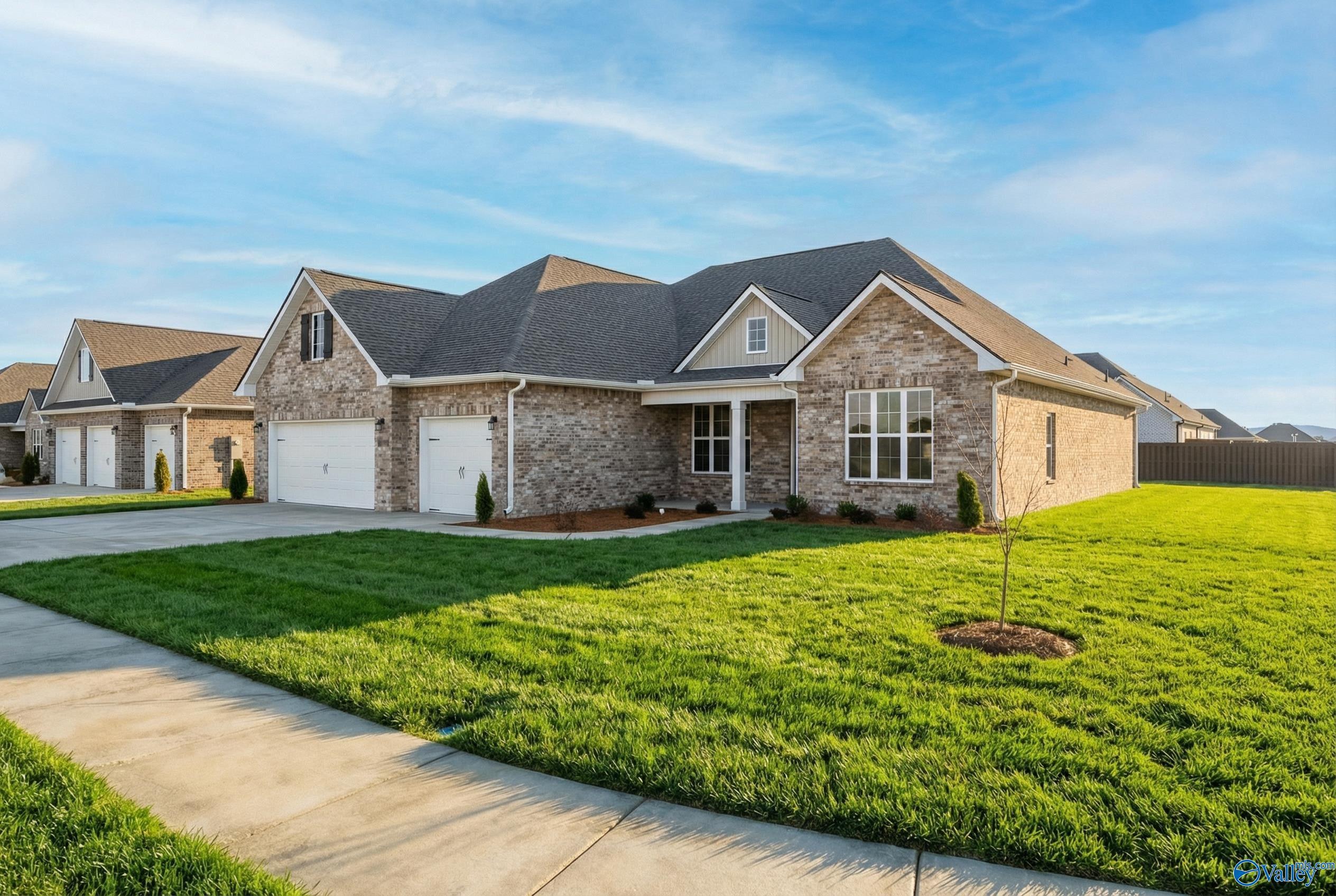 Modern 1-story brick home with 2-car garage, gabled roof, and lush green lawn in Briercreek, Meridianville, Alabama - Davidson Homes The Finleigh