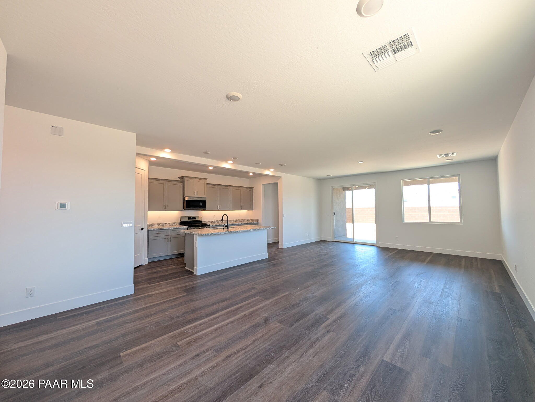 Open-concept kitchen and living area in The Frontier II F floor plan at South Ranch, Prescott, Arizona.