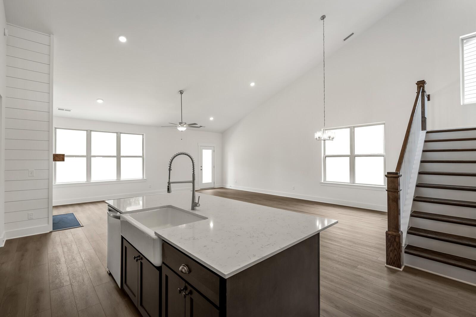 Open-concept kitchen island with farmhouse sink in The Ridgeport C floor plan at Woods Crossing, Gallatin, Tennessee.