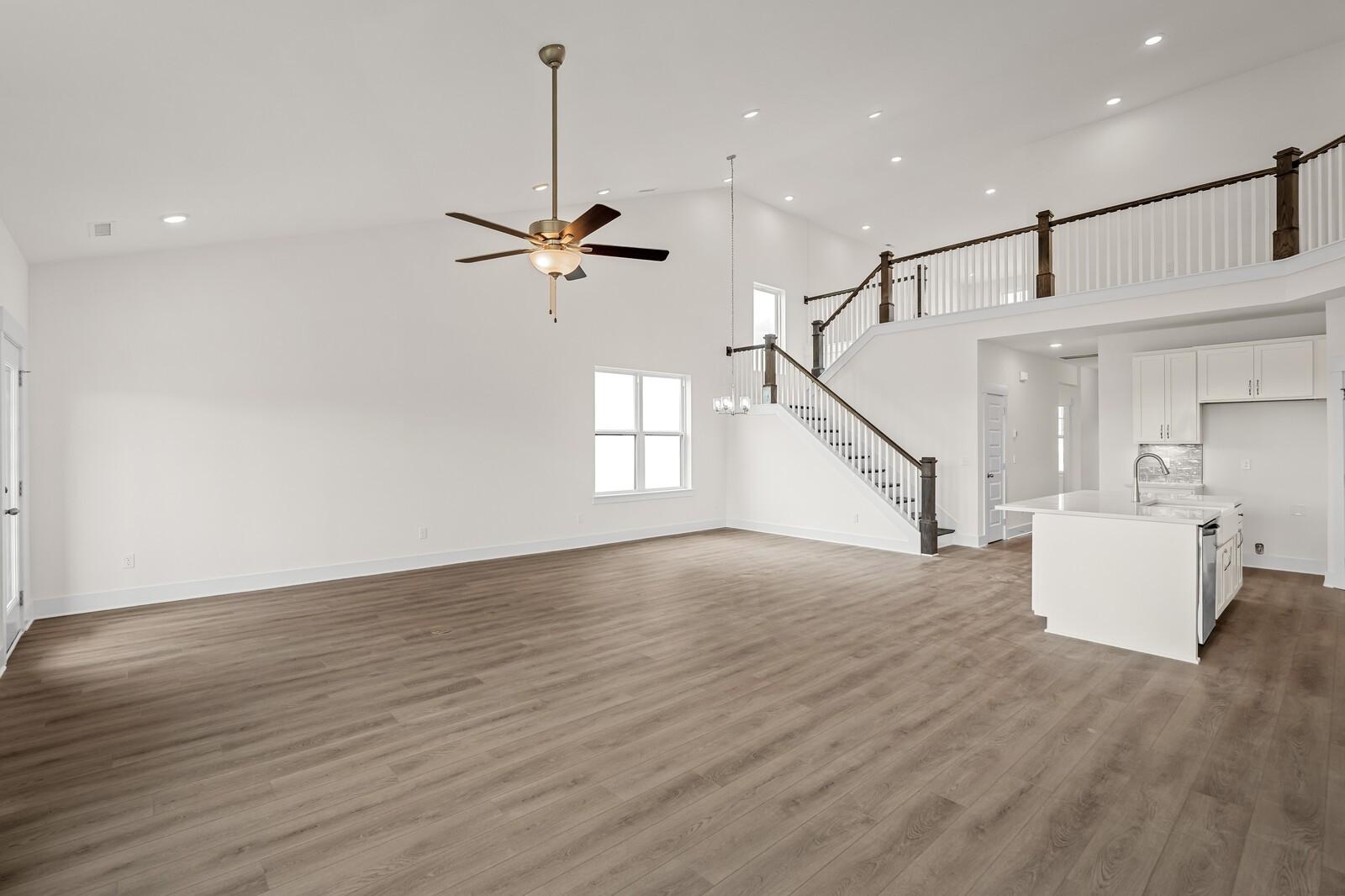 Open-concept living room with vaulted ceilings and staircase in The Ridgeport D floor plan, Benders Cove, Mt. Juliet.