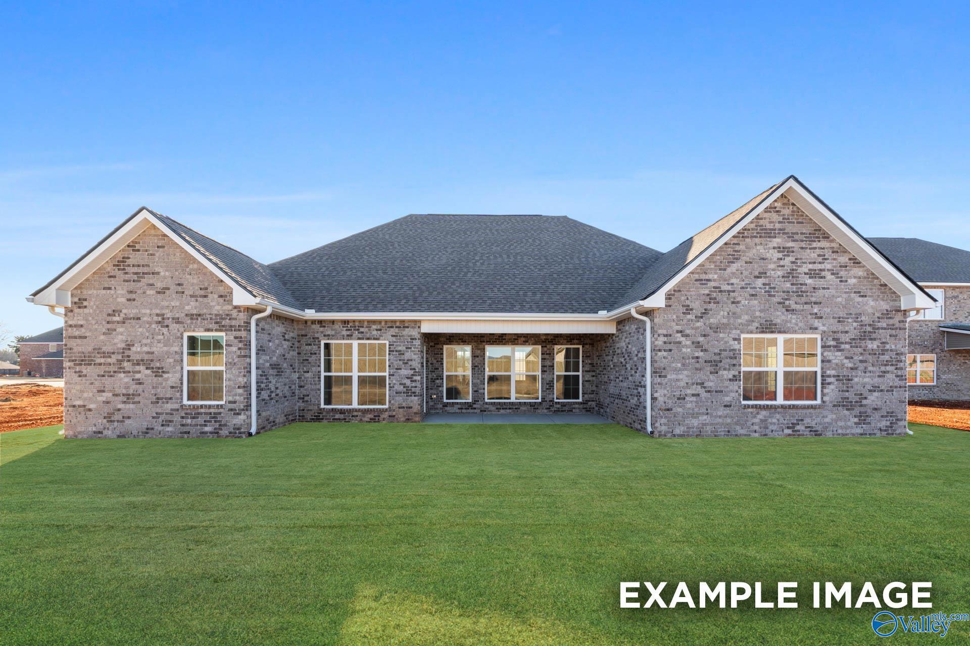 Rear exterior view of The Valencia floor plan by Davidson Homes featuring brick siding and backyard in Briercreek, Meridianville.