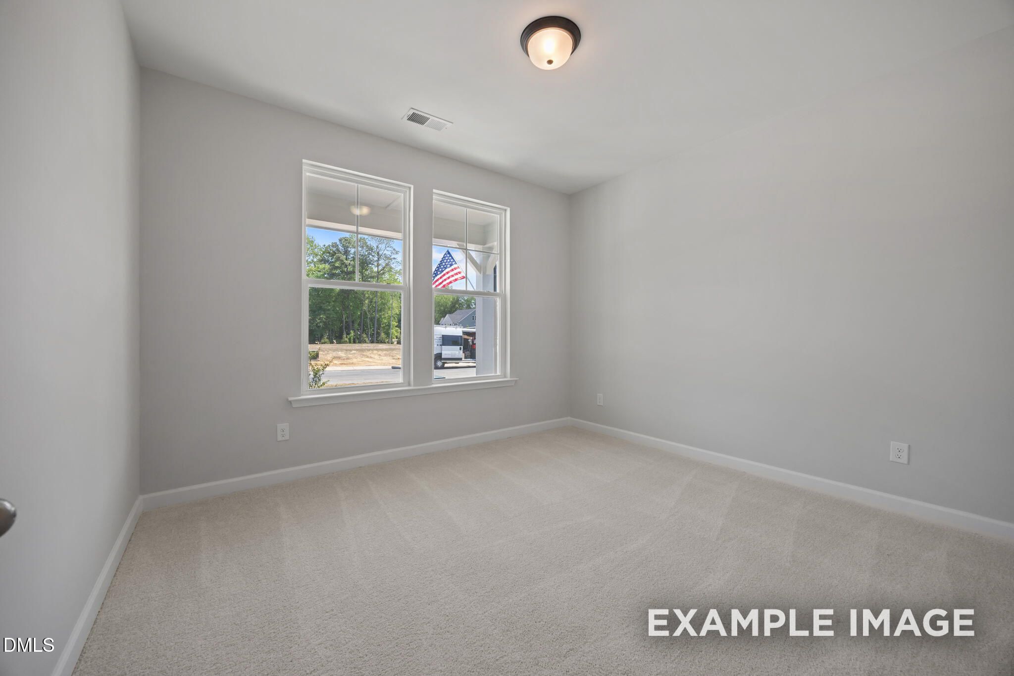 Bright empty bedroom with carpet and double windows in Davidson Homes The Beech floor plan, Wendell Ridge, Wendell, North Carolina