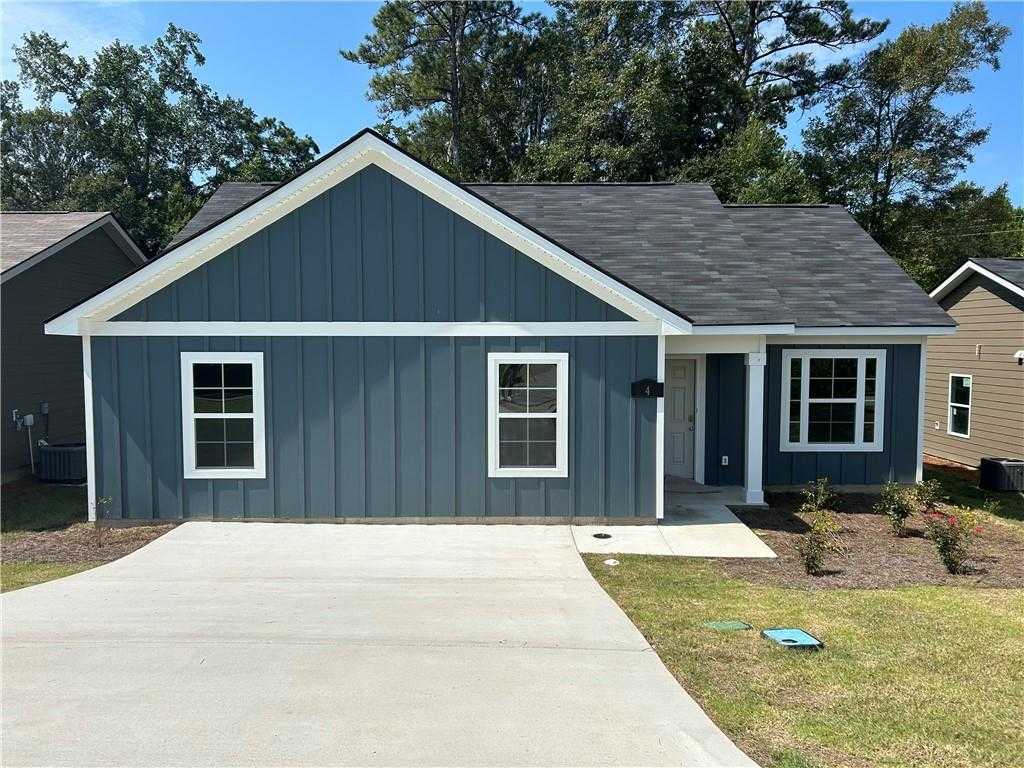 Modern navy blue 1-story home with white trim, gabled roof, front porch, and driveway in Summer Vineyard, Phenix City, Alabama