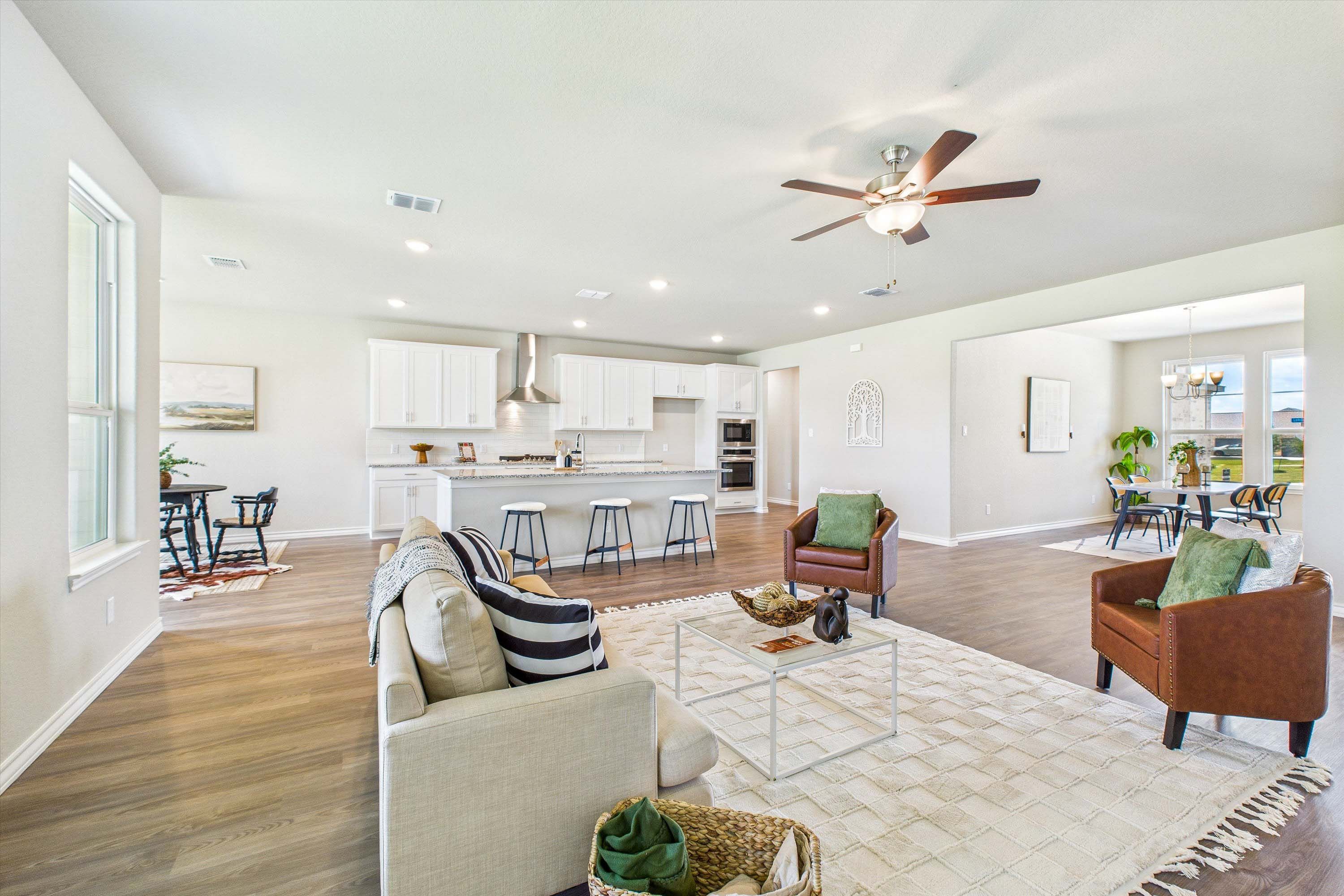 Open-concept living room and kitchen in The Foster by Davidson Homes featuring a spacious island and modern design.