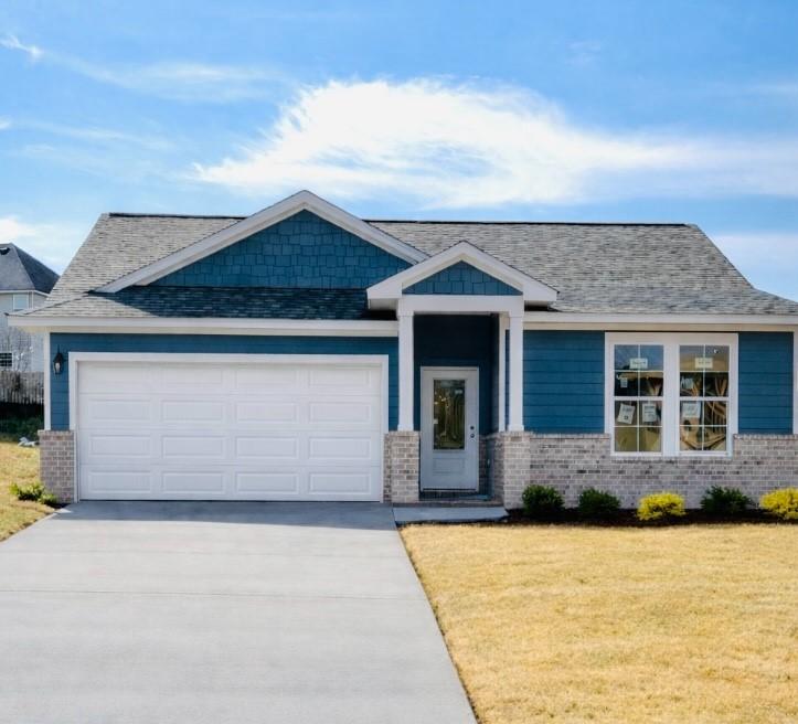 Navy blue single-story home with 2-car garage, brick accents, and landscaped front yard in Anderson Lakes, Opelika, Alabama - Davidson Homes Phoenix B