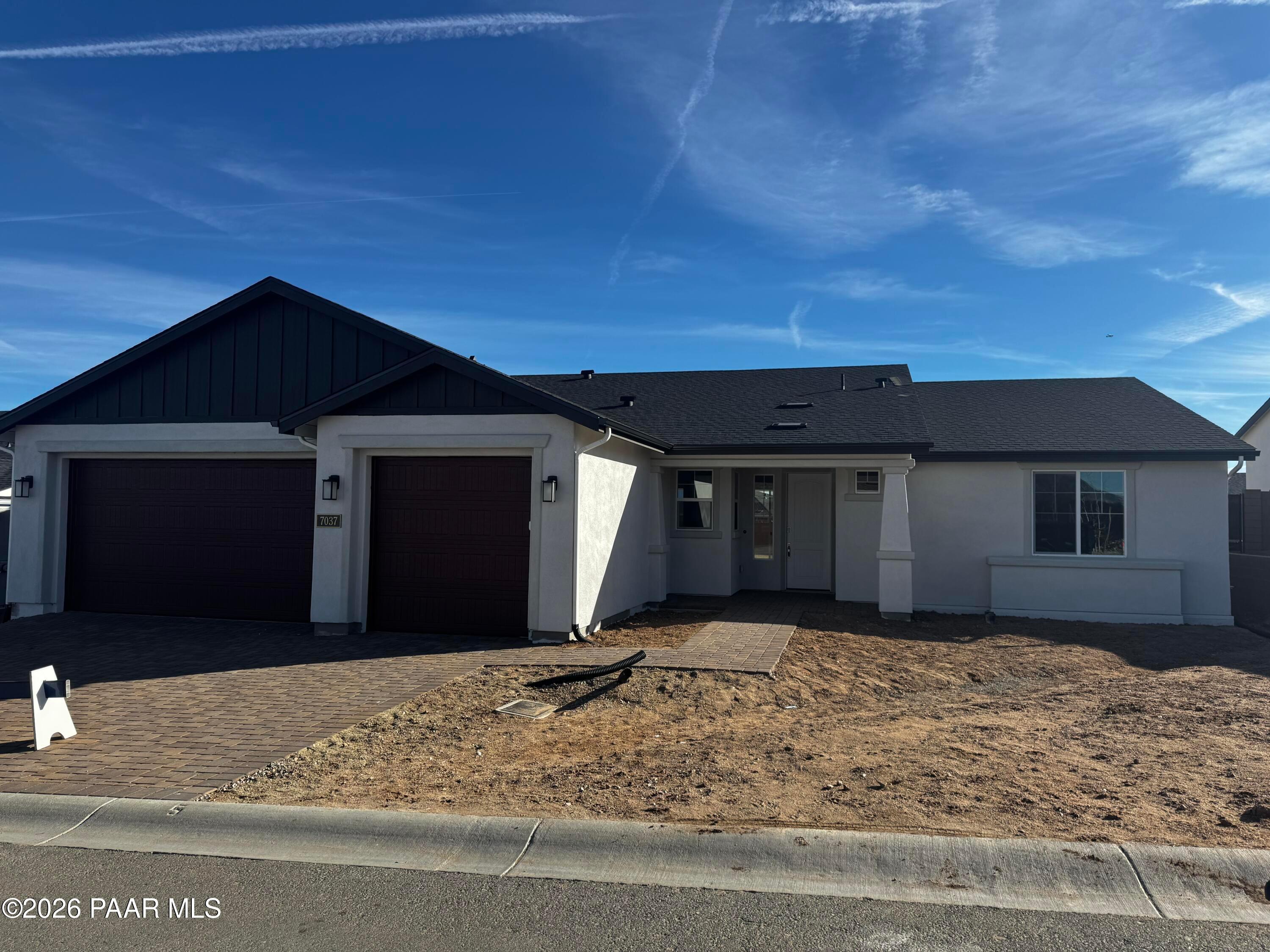 Modern single-story home with 3-car garage, dark metal roof, white stucco walls in Westwood, Prescott, Arizona - Davidson Homes Daybreak B