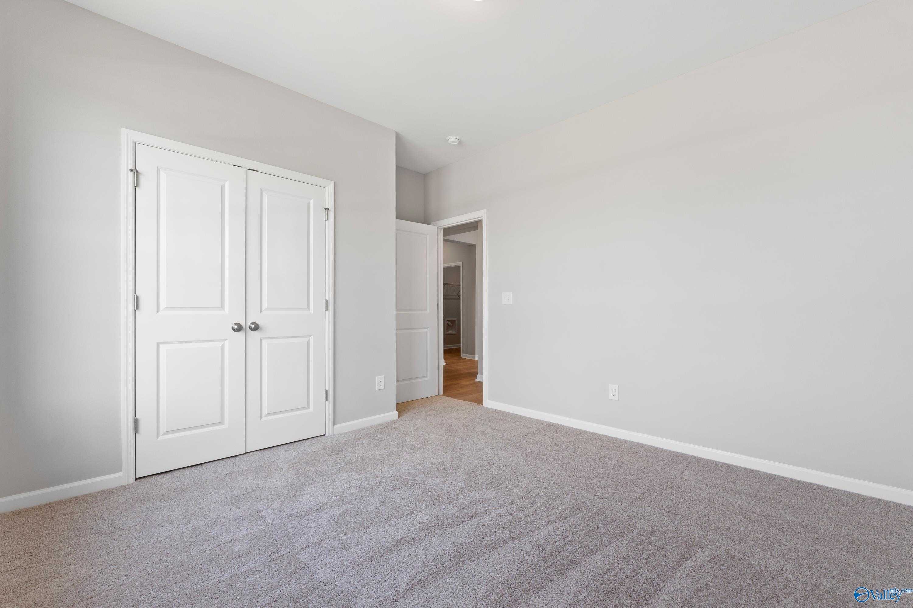 Bright master bedroom with double closet doors and en-suite entry in Davidson Homes The Orion, Athens Alabama