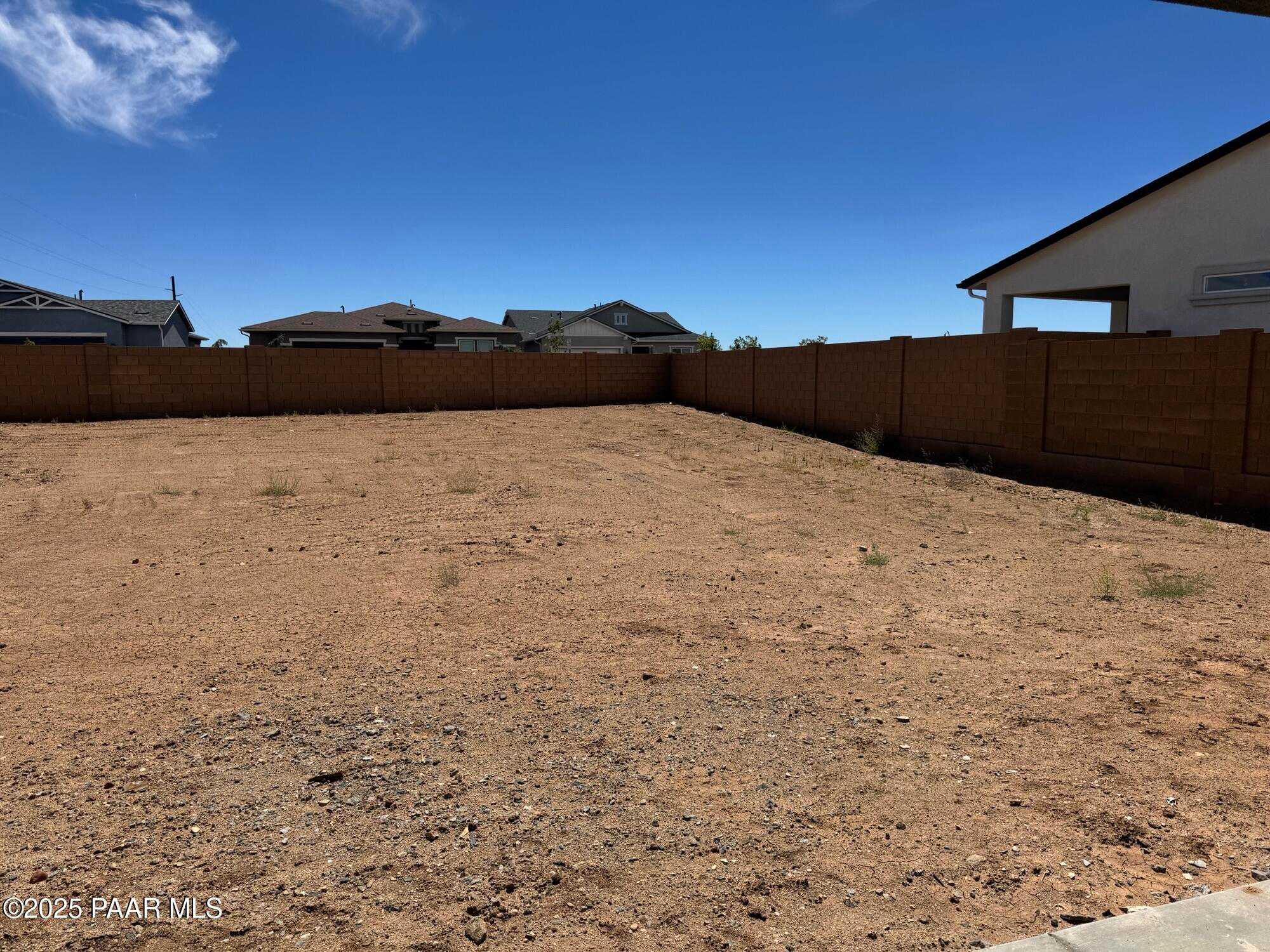 Empty fenced backyard lot with desert terrain in Westwood, Prescott, Arizona 3-bedroom Davidson Homes Sheridan II B