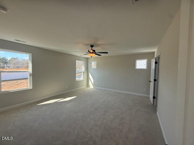 Bright empty bedroom with ceiling fan, large windows, and natural light in Davidson Homes The Willow D, Zebulon, NC