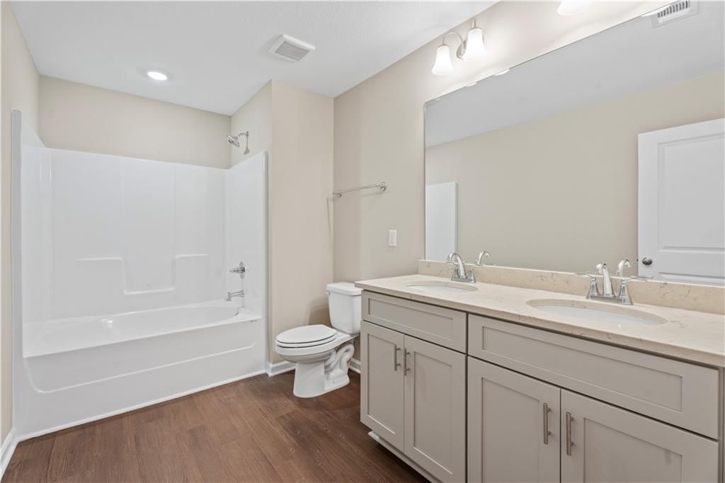Modern master bathroom featuring double vanity, soaking tub, walk-in shower in Davidson Homes The Washington, Phenix City, AL