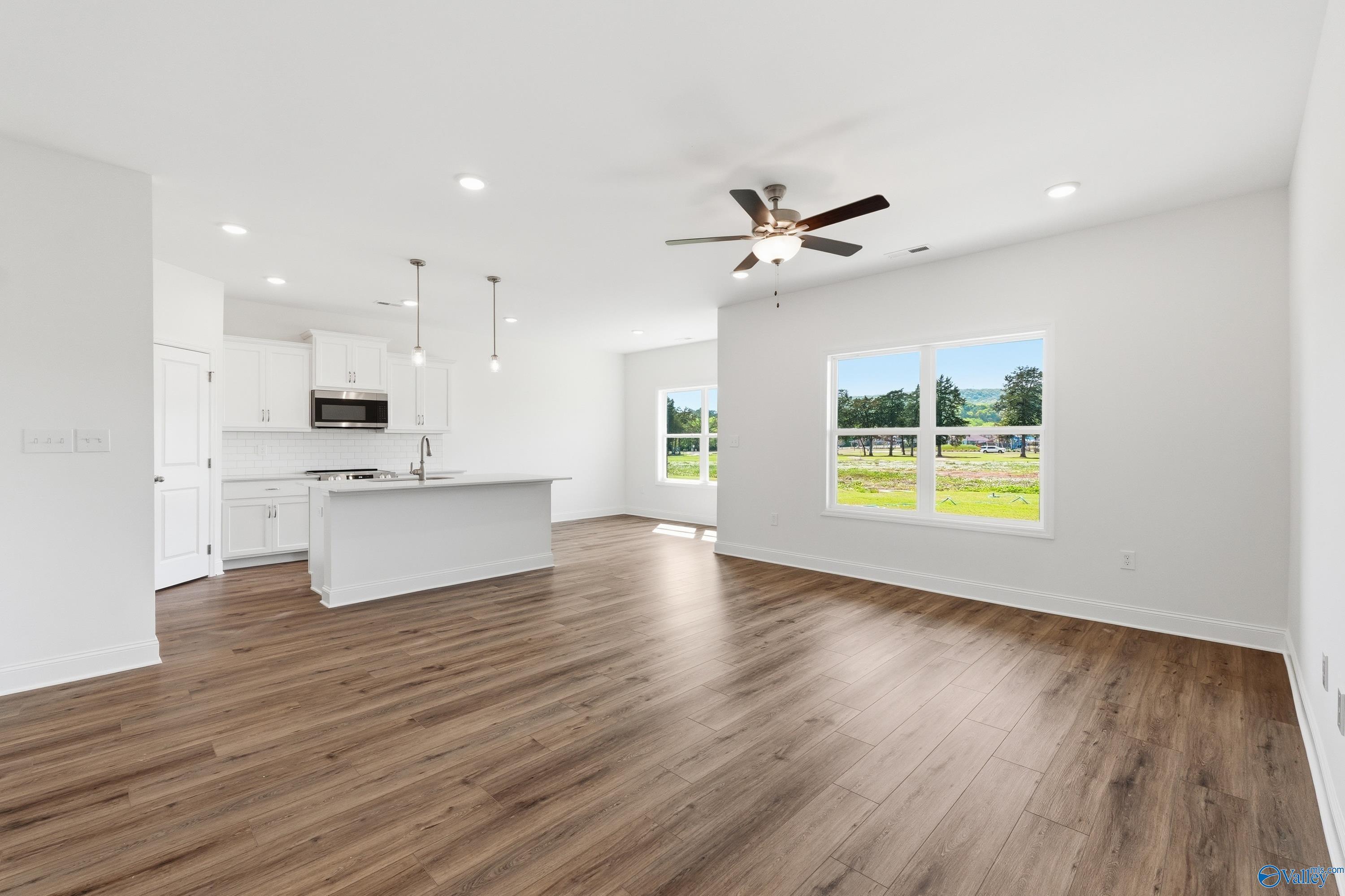 Open-concept living room and kitchen in The Asheville floor plan at Jaguar Hills, Huntsville, Alabama.
