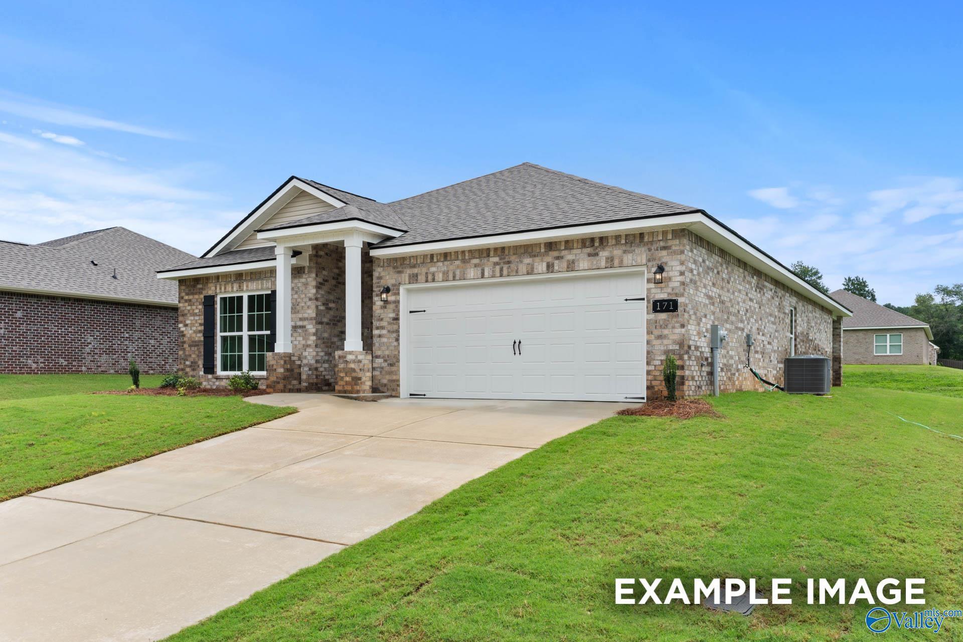 Brick 1-story Daphne floor plan home by Davidson Homes with 2-car garage, columned entry, driveway, and green lawn in Clearview, Hazel Green, Alabama