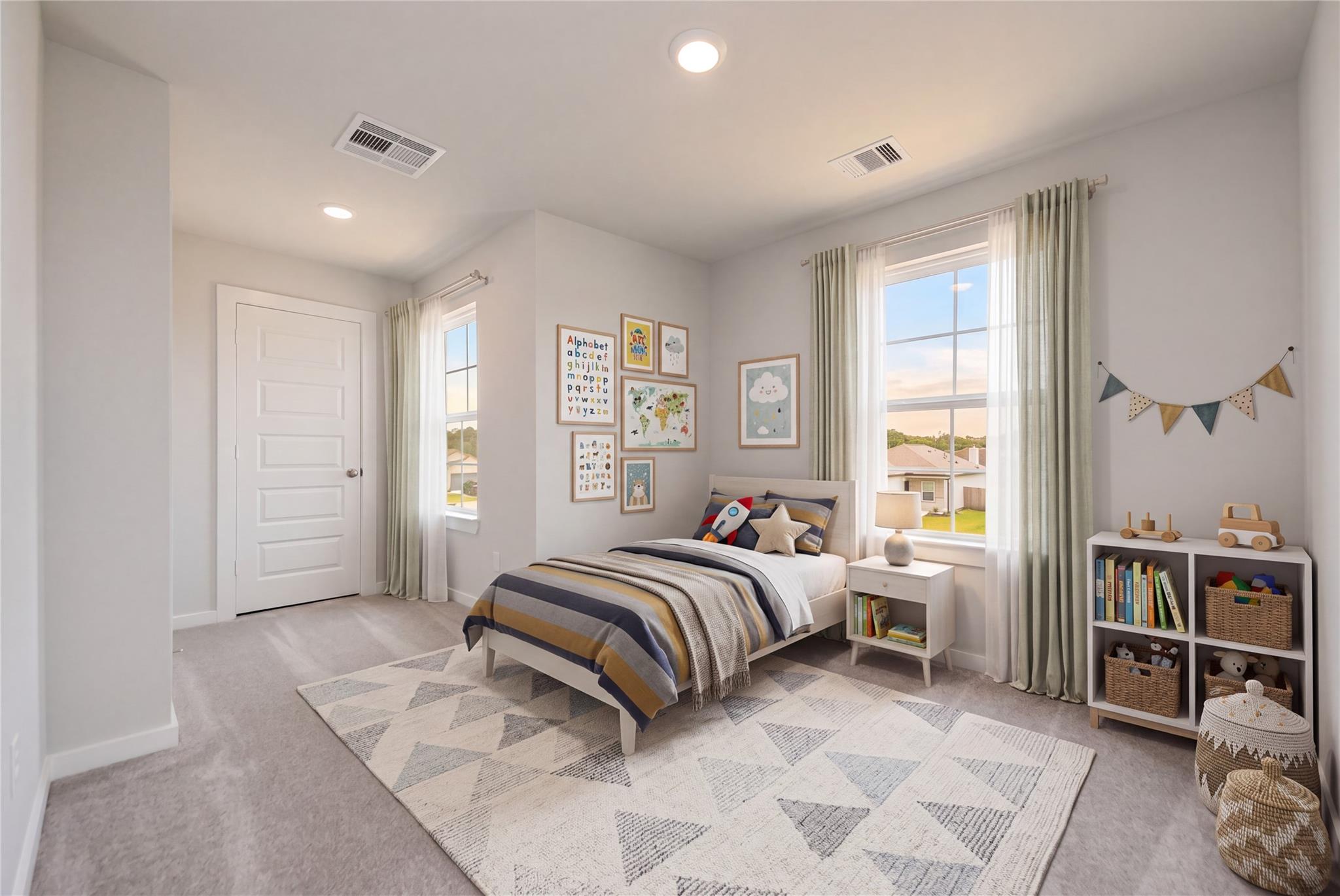 Bright bedroom with twin bed and gallery wall in Davidson Homes' The Blanco E floor plan, Dayton, Texas