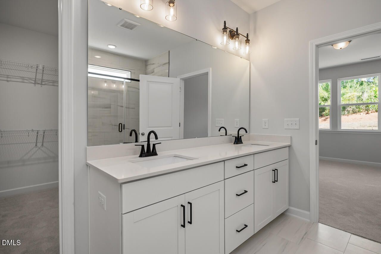 Modern primary bathroom with dual-sink vanity in The Birch II E floor plan at Sage on North Main, Wake Forest, NC.