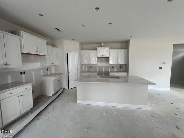 Modern white shaker kitchen with quartz island, stainless hood, and recessed lights in The Preston A 4-bedroom home, Lillington NC