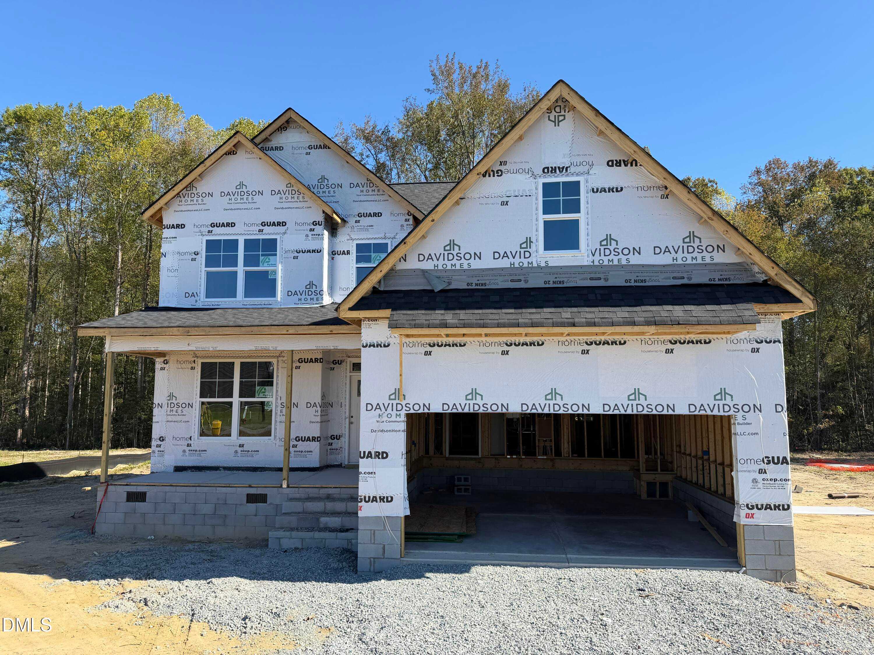 Two-story Davidson Homes The Ash B under construction in Wellers Knoll, Lillington, NC, with front porch, 2-car garage, and autumn trees