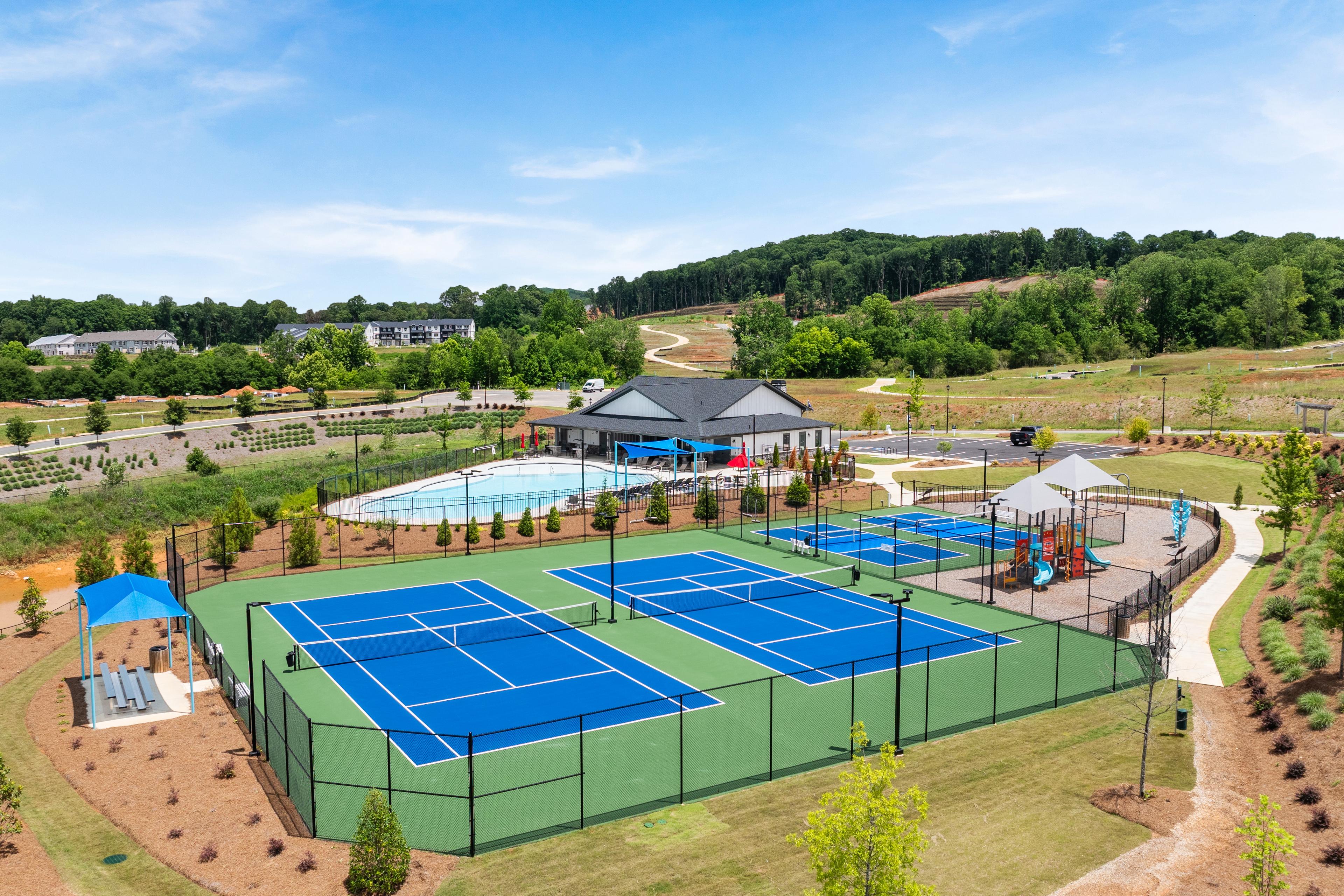 Tennis courts, swimming pool, and playground at Hemingway in Cumming, GA, a community built by Davidson Homes.