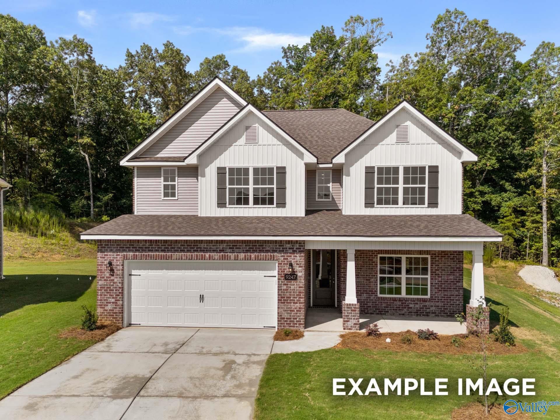 Two-story 4-bedroom Davidson Homes Shelby C with white siding, brick accents, two-car garage and front porch in The Highlands, Arab, Alabama