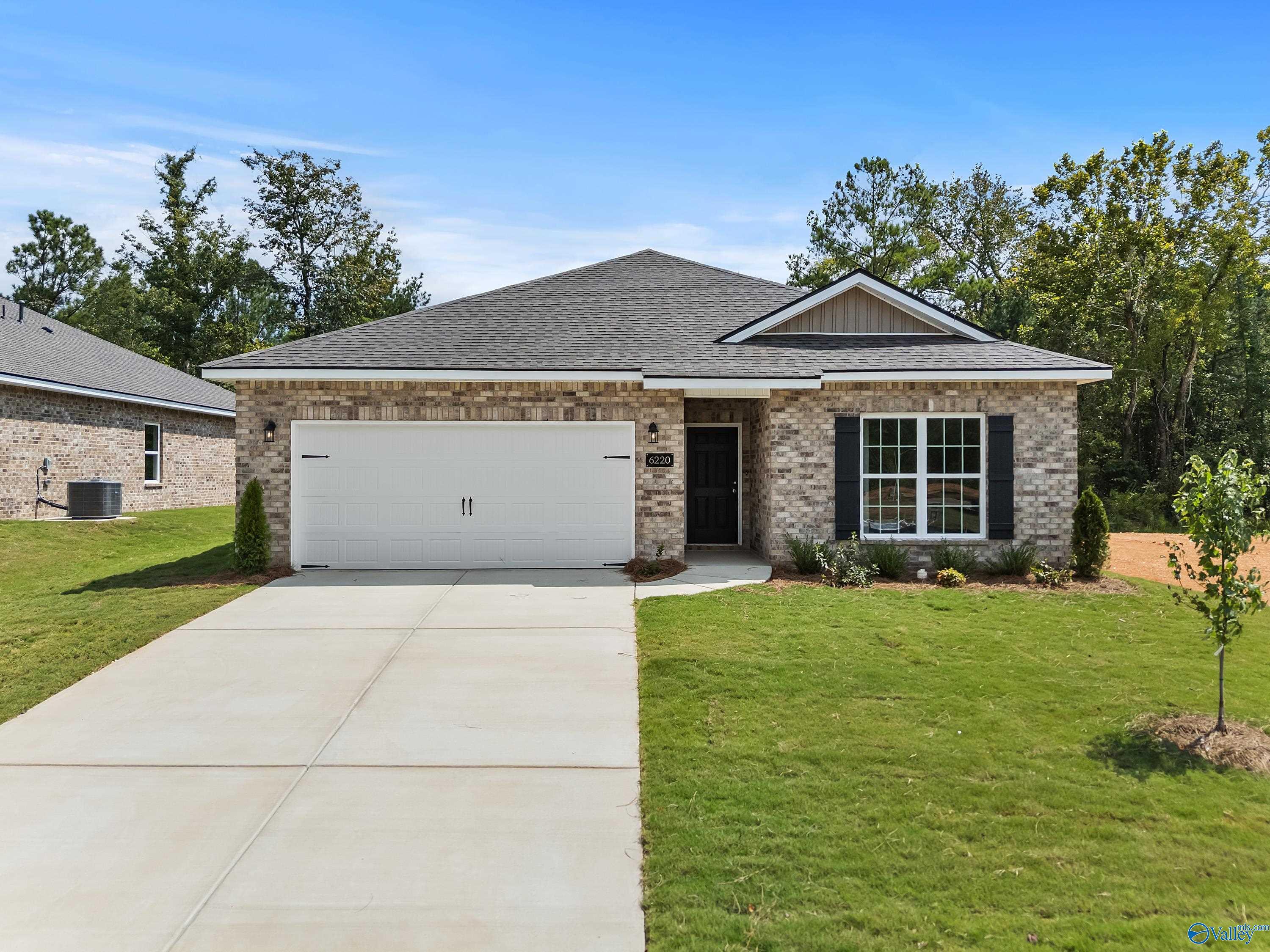 Modern 1-story brick home with 2-car garage, driveway, and lush landscaping in Spragins Cove, Huntsville, Alabama - Davidson Homes The Franklin