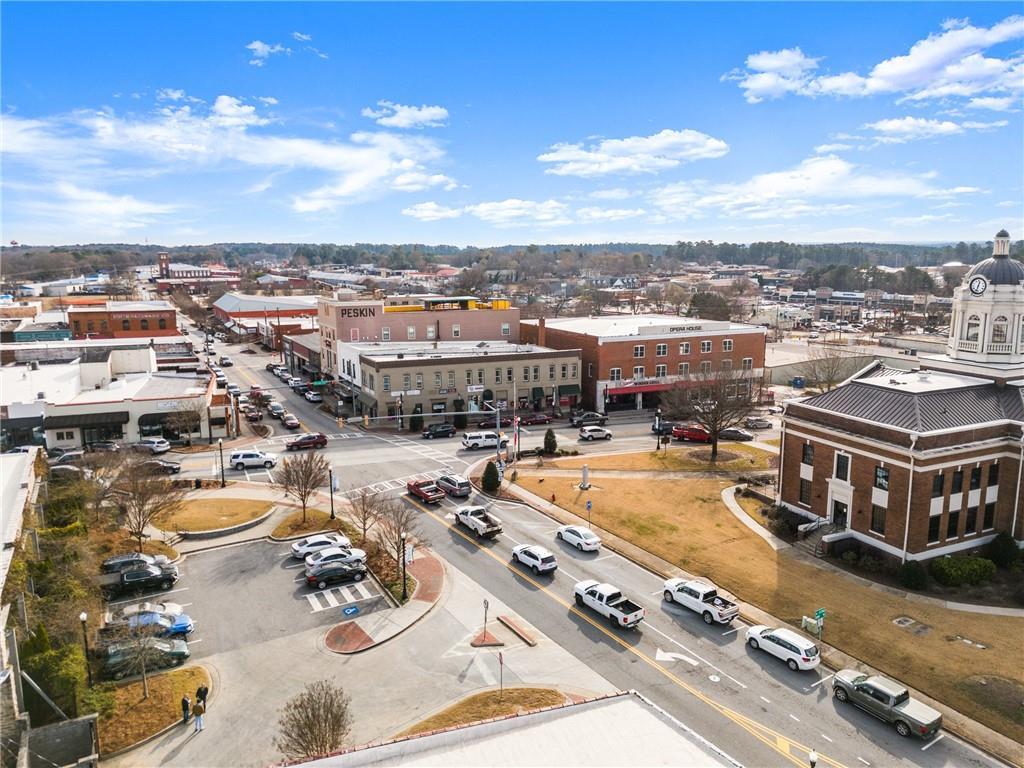 Aerial view of historic downtown Winder, Georgia, with brick courthouse, tree-lined streets, and parked cars near Cedar Farms Davidson Homes