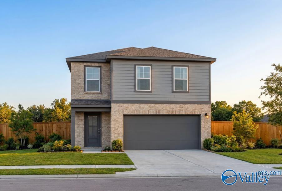 Two-story brick and siding home with 2-car garage, front porch, and landscaped yard in Walker's Hill, Meridianville, Alabama