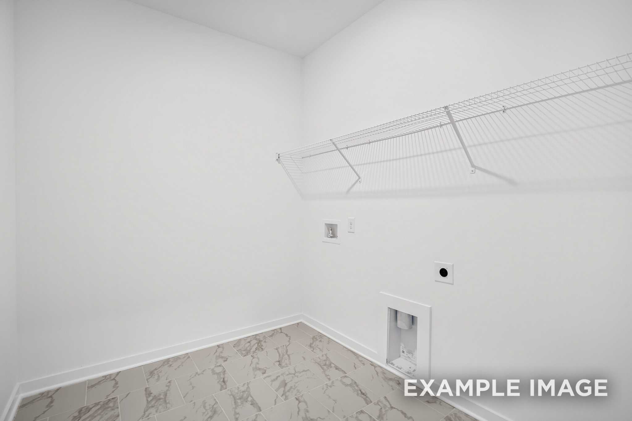 Spacious laundry room in The Murray B with white walls, wire shelving, utility sink, and marble-look vinyl flooring