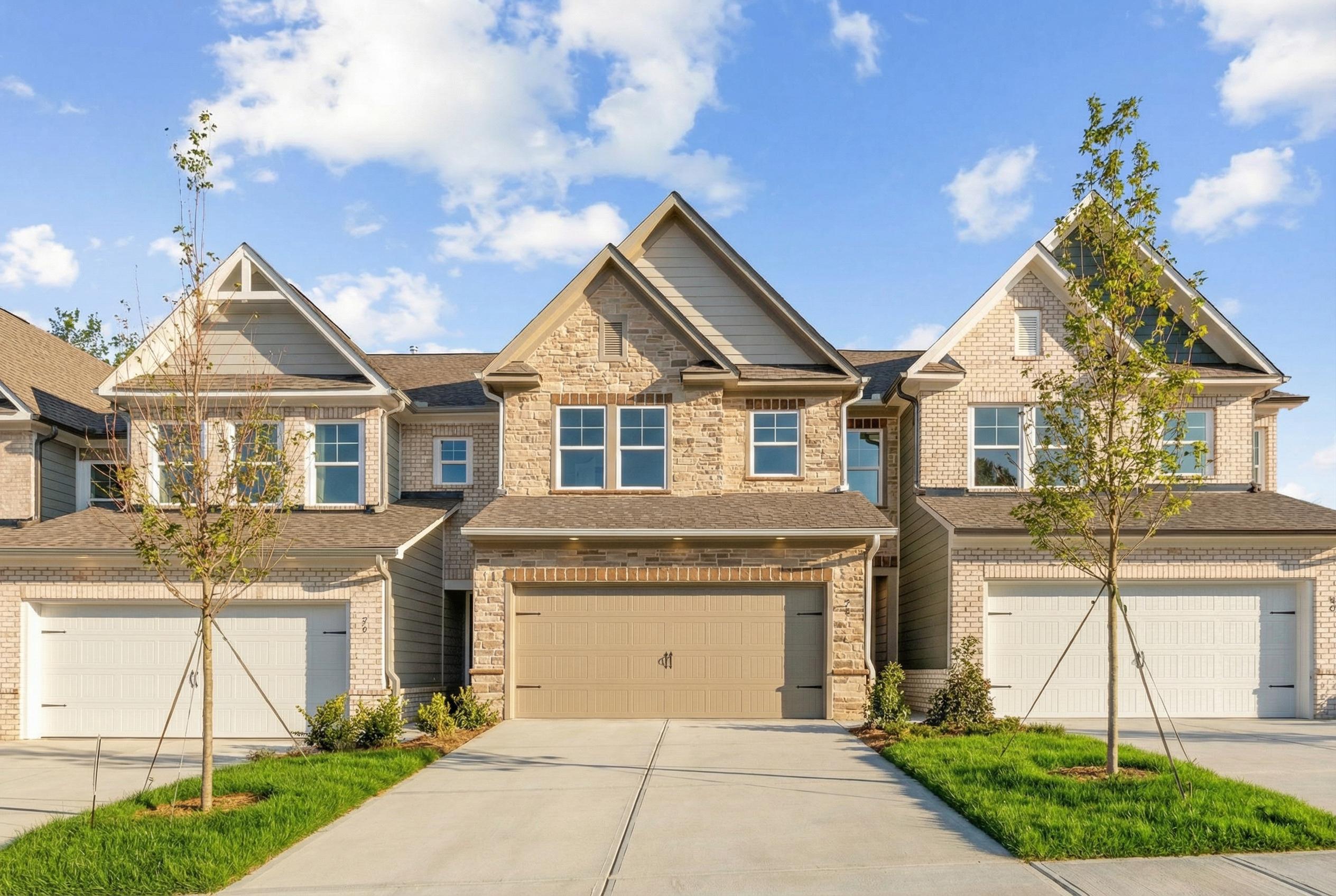Modern 2-story Cary C home exterior by Davidson Homes with stone accents, 2-car garage, driveway in Lake Shore, Winder, Georgia