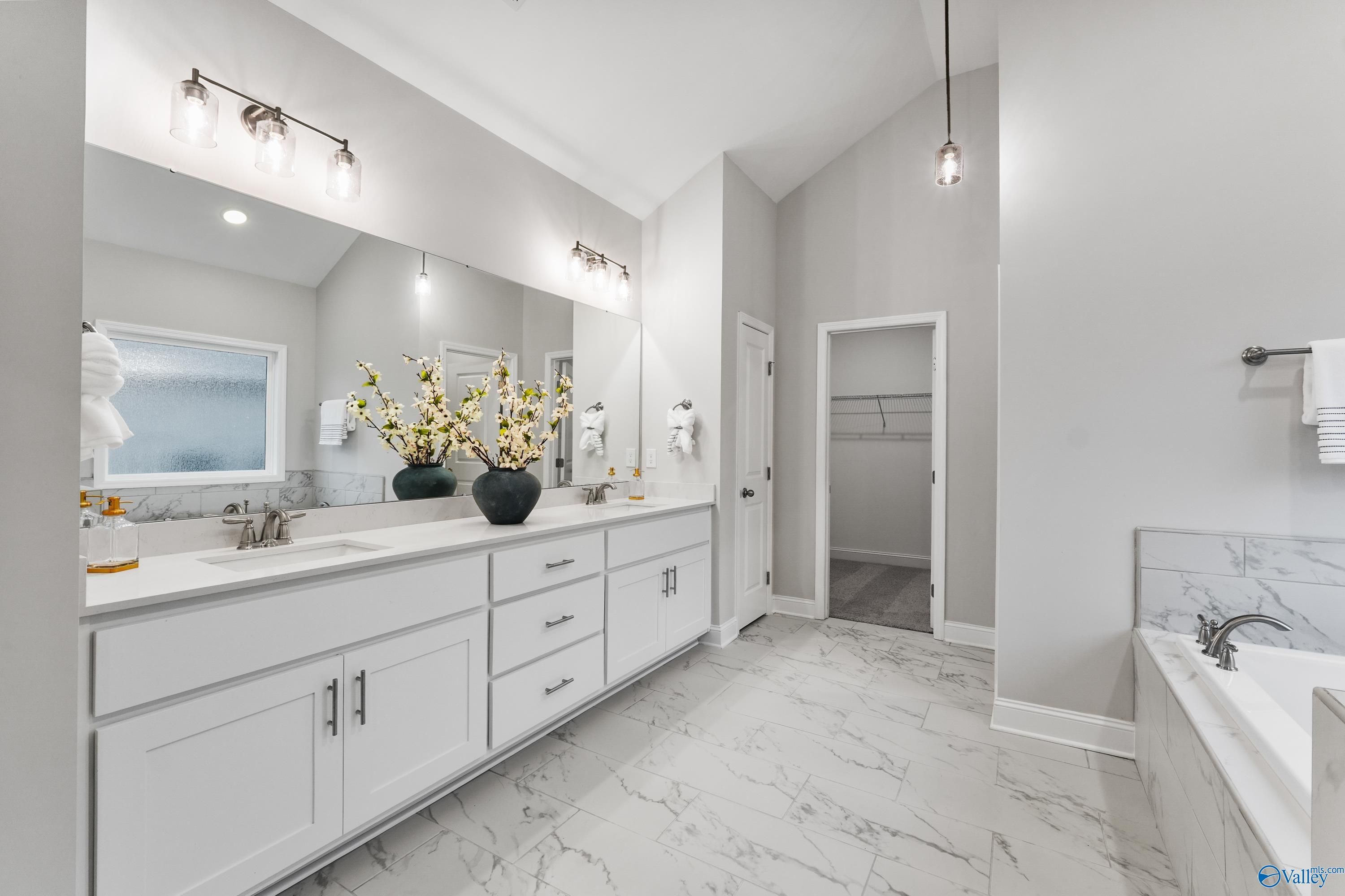 Luxurious master bathroom with double marble vanity, freestanding tub, and pendant lights in Davidson Homes The Finleigh, Toney, Alabama