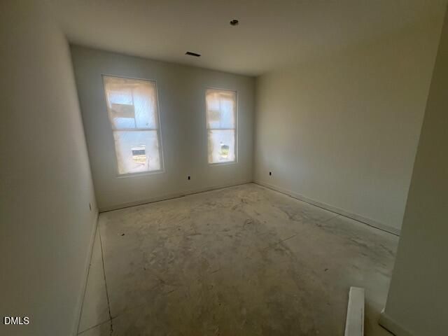Unfinished bedroom with two windows and concrete floors in new construction Davidson Homes Magnolia II B plan, Lillington NC