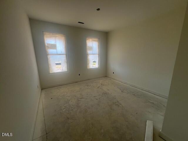 Unfinished bedroom with two windows and concrete floors in new construction Davidson Homes Magnolia II B plan, Lillington NC