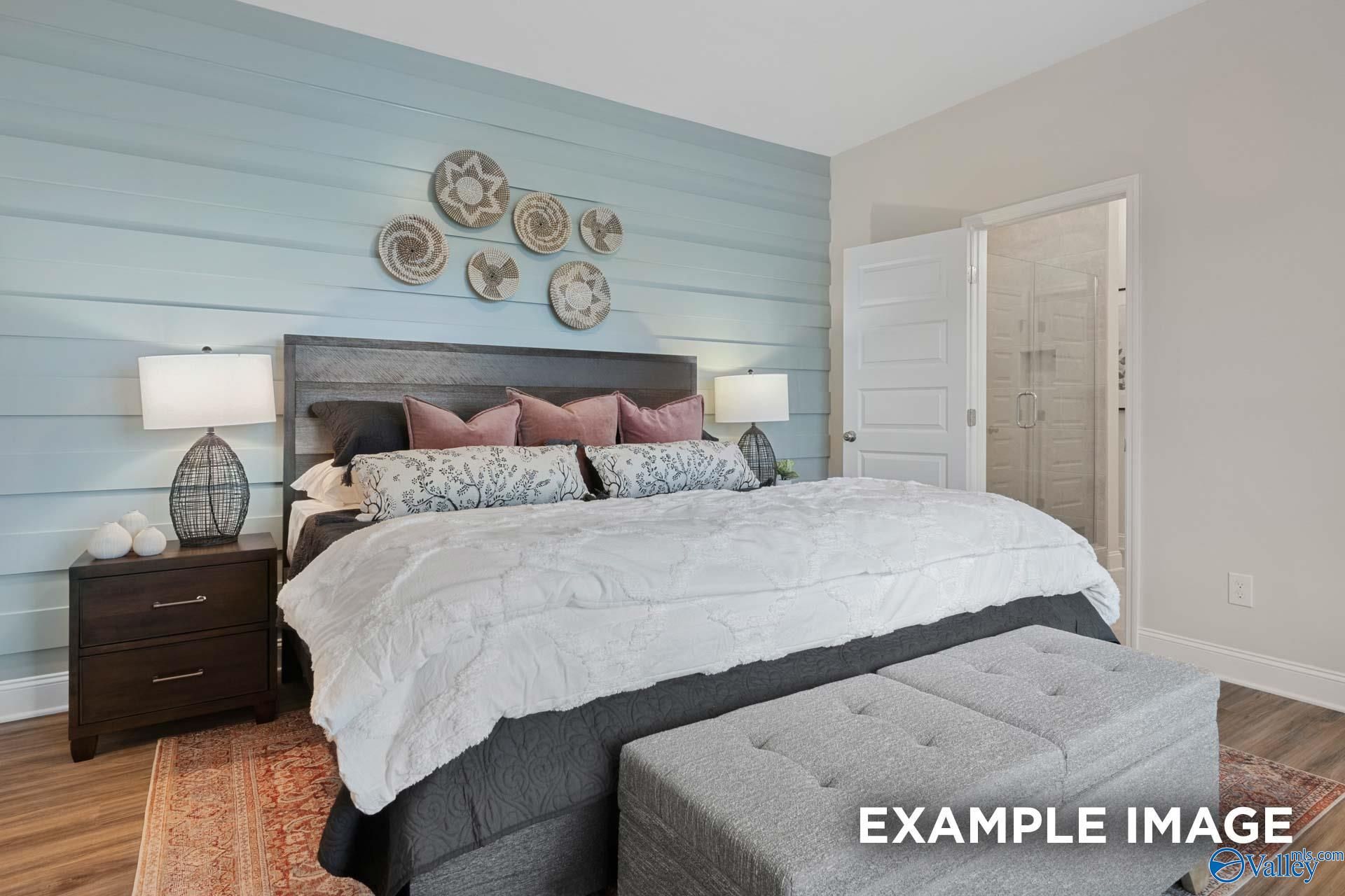 Serene master bedroom with shiplap accent wall and ensuite bath in Davidson Homes The Camilla C, Hartselle, Alabama