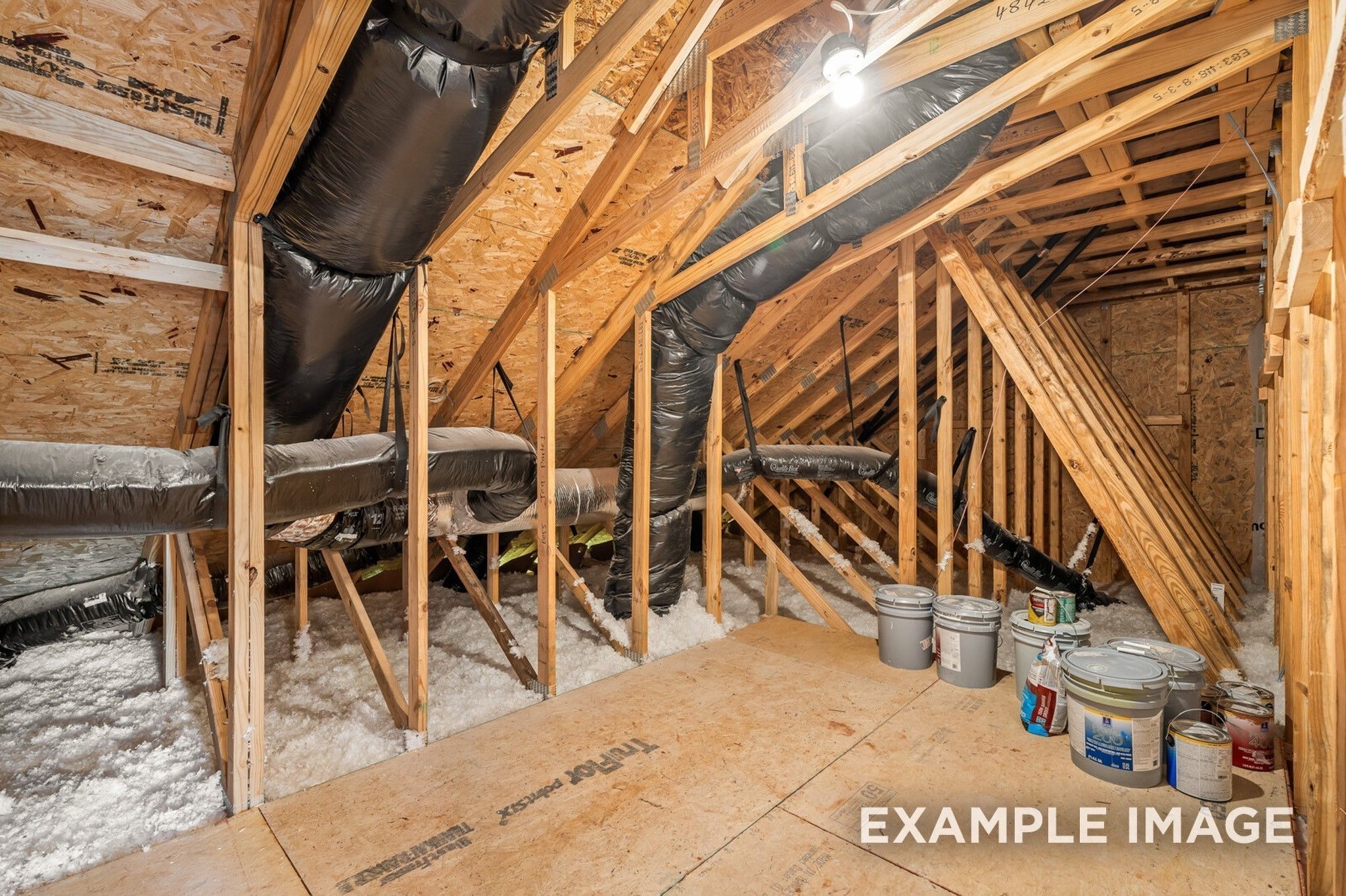Exposed wooden framing, HVAC ducts, and insulation in unfinished interior of Davidson Homes The Ash A, Gallatin, Tennessee