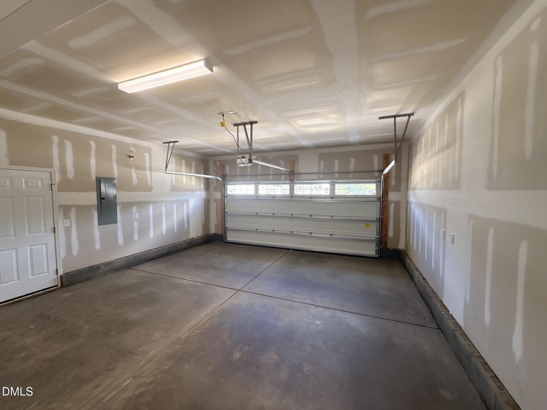 Spacious unfinished 2-car garage in The Ash C floor plan by Davidson Homes in Woodland Crossing, Zebulon, North Carolina.