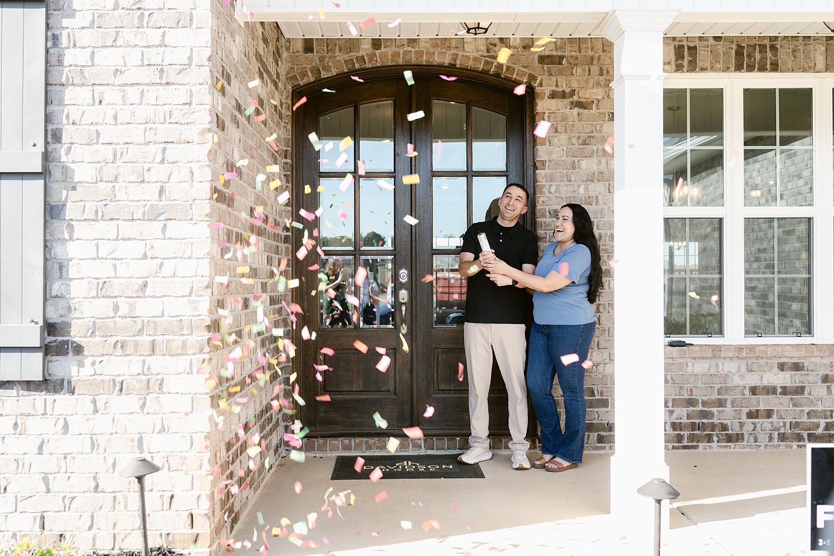 Smiling blonde woman in cozy home office attends Davidson Homes virtual homebuyer seminar on MacBook laptop with books and plants