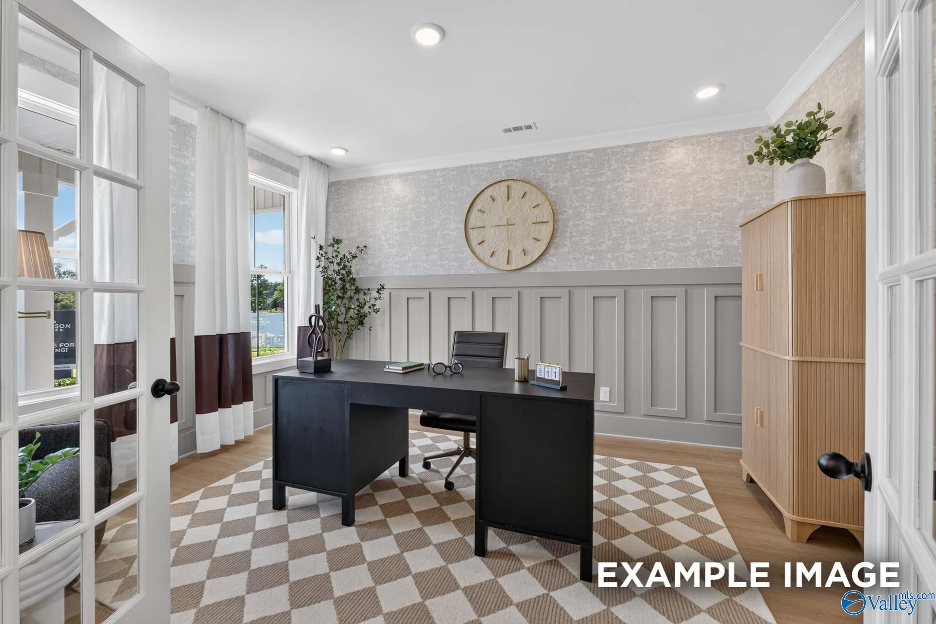 Elegant home office with black desk, wainscoting walls, and French doors in Davidson Homes Ashport K plan, Forest Glen, Hazel Green