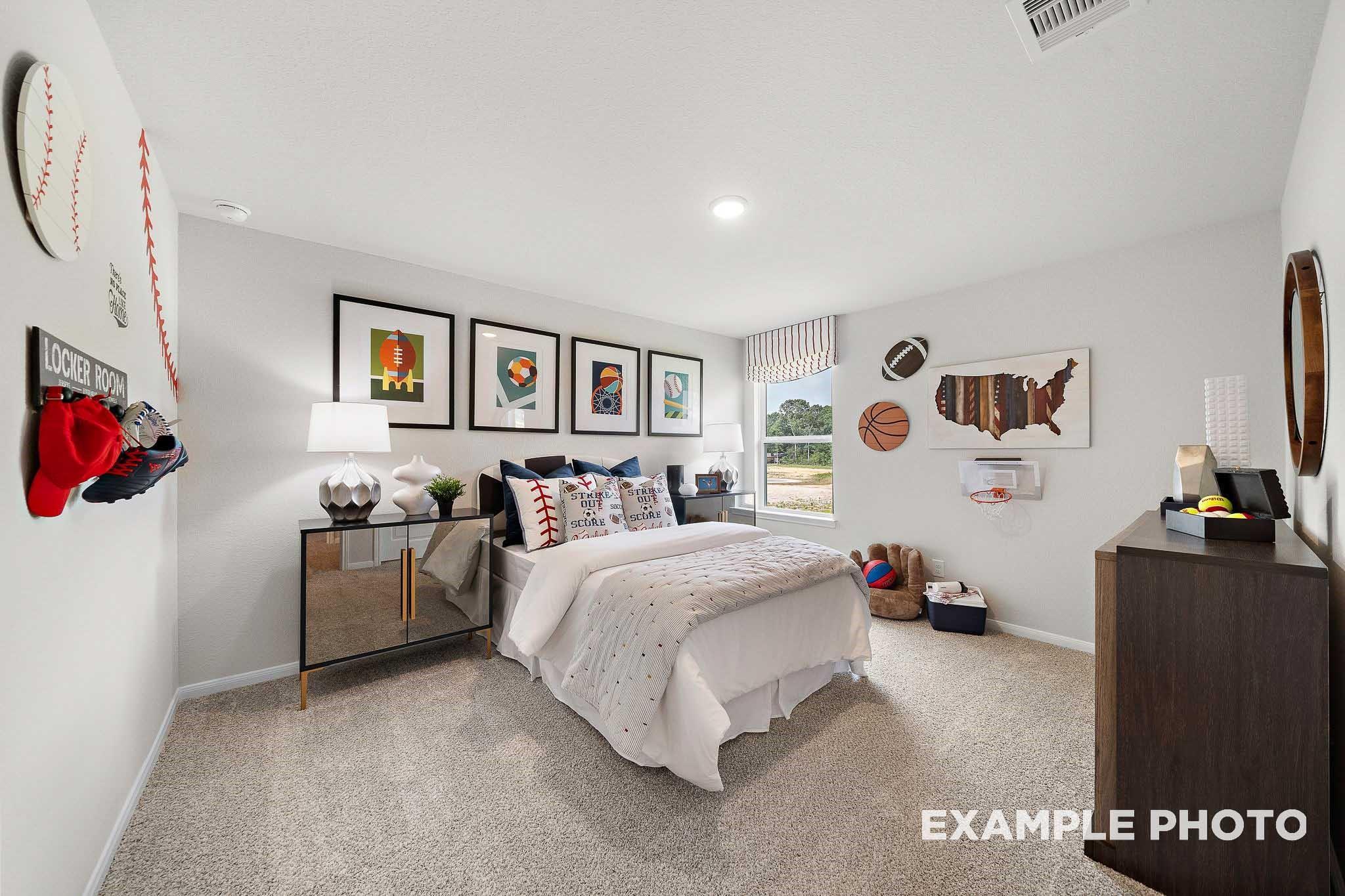 Sports-themed children's bedroom with white bed, framed art, baseball glove and football helmet in 5-bedroom San Marcos E home, Conroe, Texas