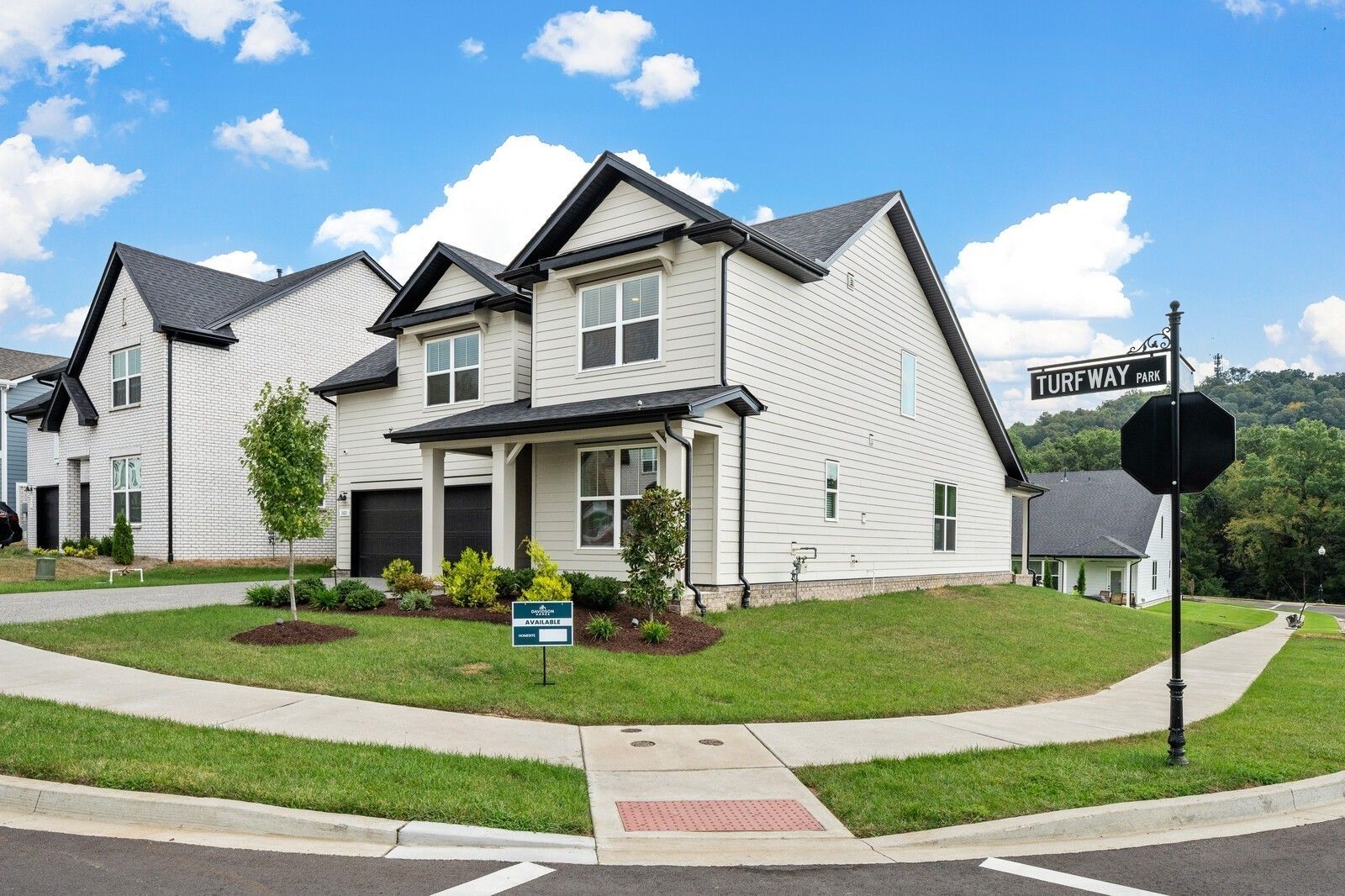 Modern two-story 4-bedroom home with 2-car garage, landscaped yard, and for-sale sign on Turff Way in Carellton, Gallatin, Tennessee