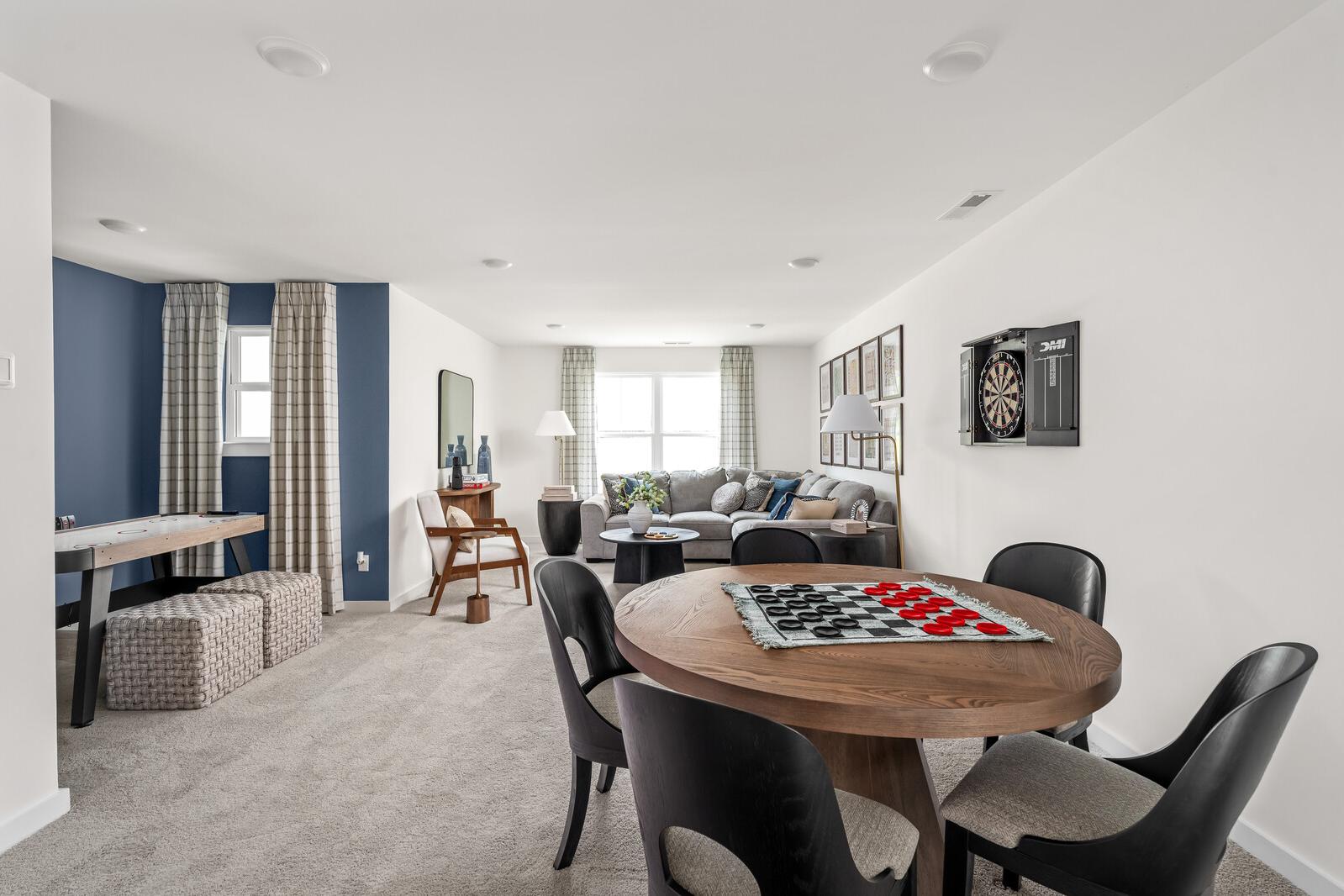Spacious game room at Woods Crossing in Gallatin TN with pool table, checkers board, sofa, and dartboard accents