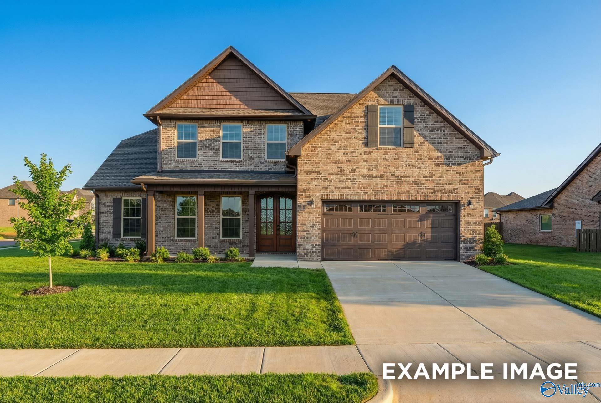 Two-story brick home with covered front porch, 2-car garage, and lush lawn in Hollon Meadow, Decatur, Alabama - Davidson Homes The Emory