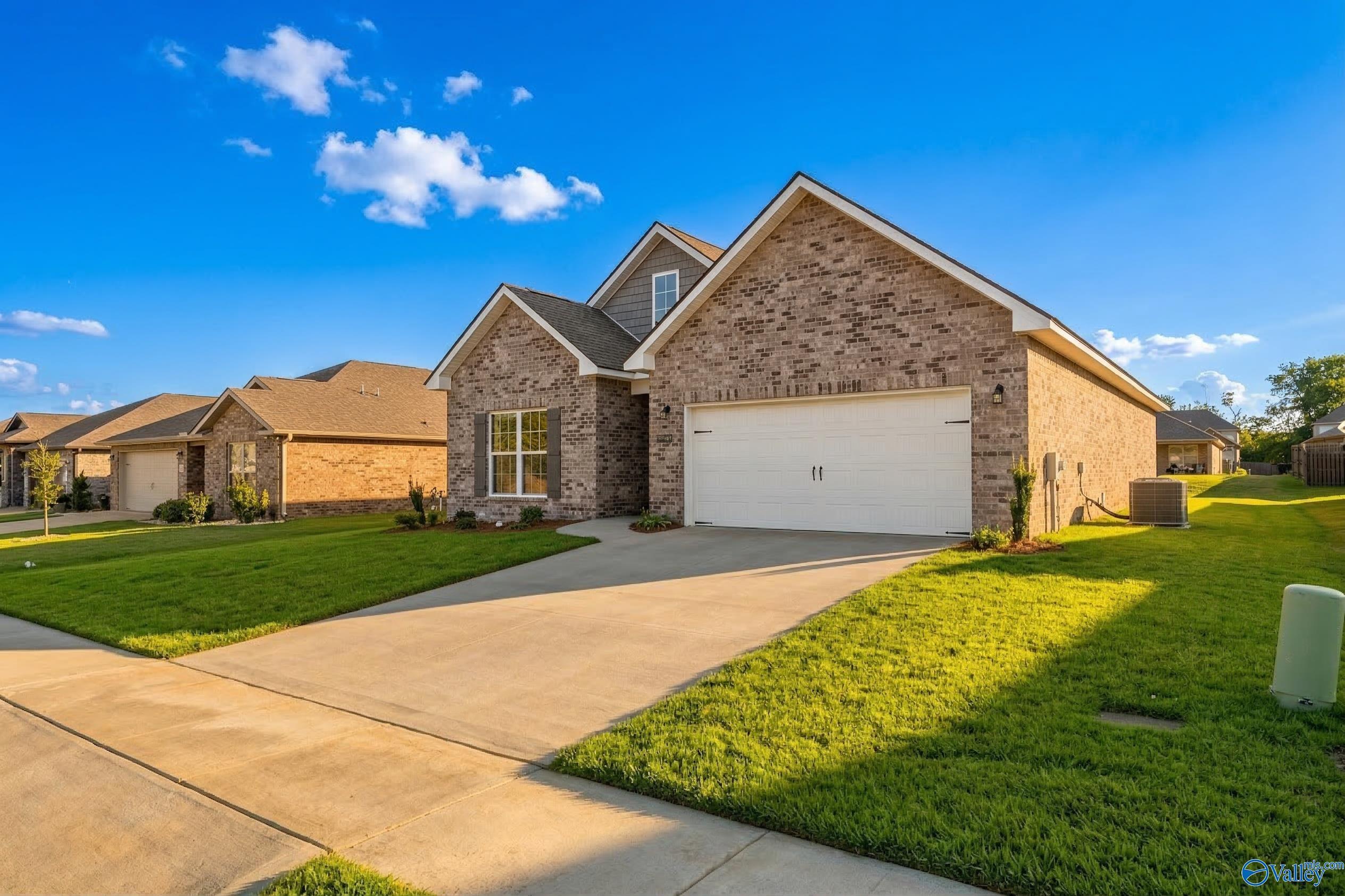 Brick single-story home with 2-car garage, manicured lawn, and driveway in Flint Meadows, New Market, Alabama - Davidson Homes The Franklin C